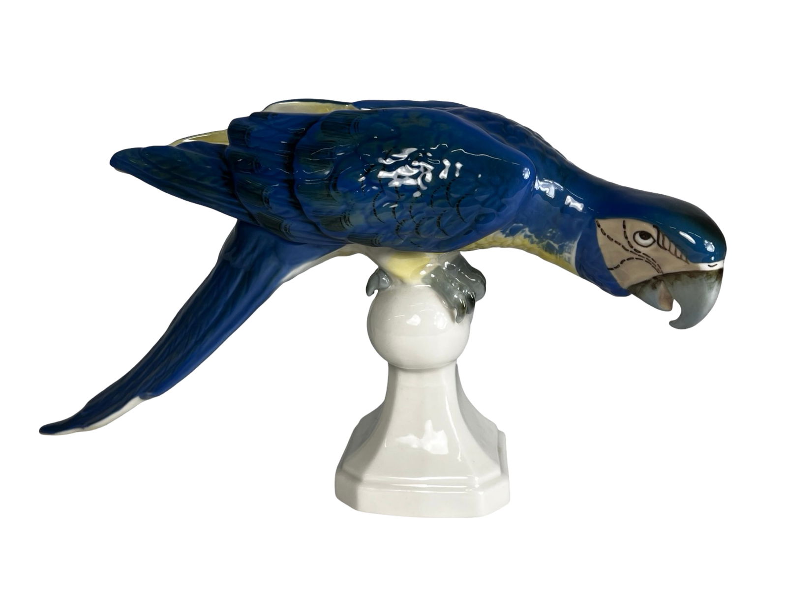 Royal Dux Blue Macaw Parrot Porcelain Figurine: Striking Royal Dux porcelain figurine depicting a vibrant blue macaw parrot perched on a pedestal form base. The sculpture features finely modeled feather details and rich hand-painted coloration in