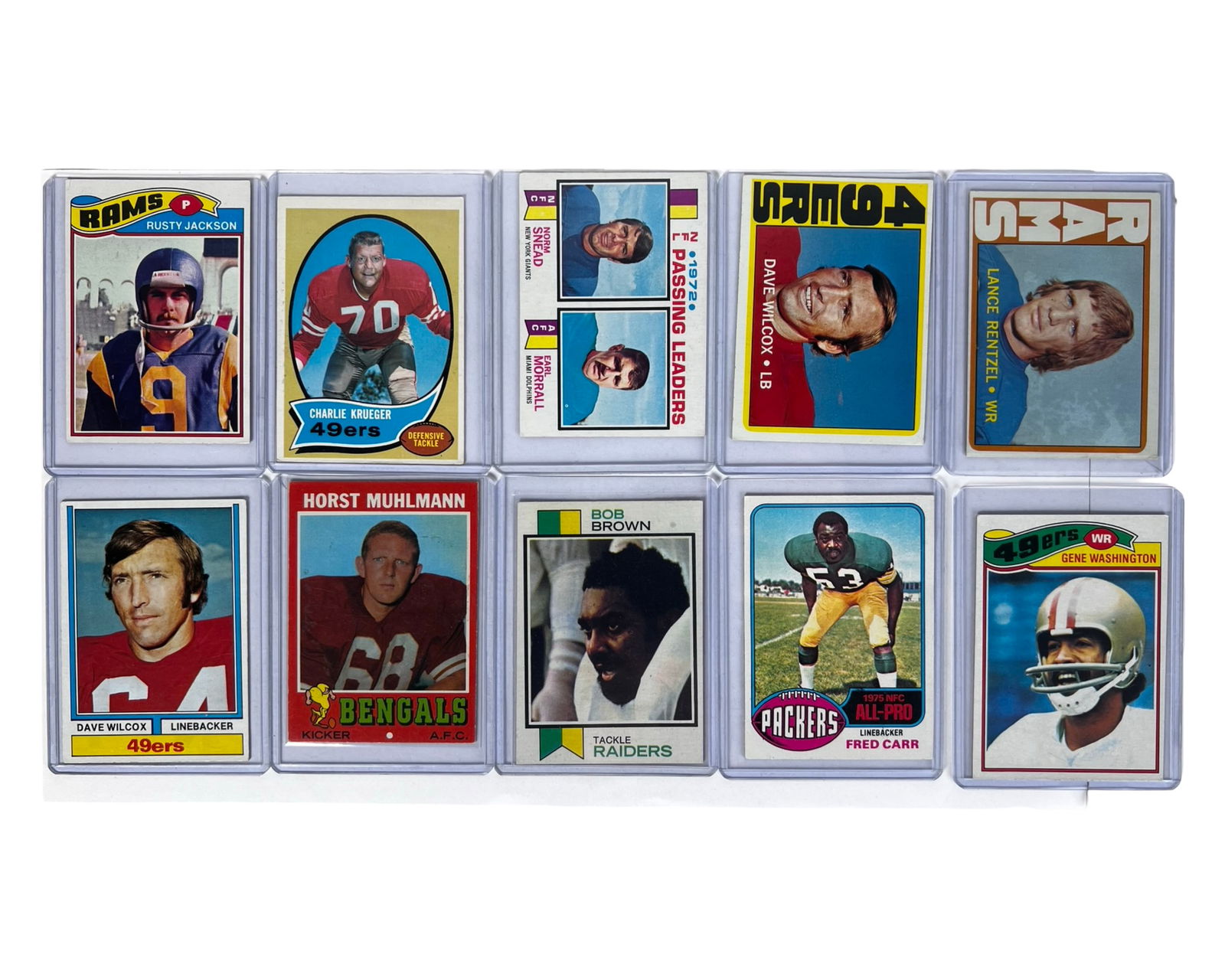 Group of Vintage Football Cards: Group of ten vintage football trading cards featuring notable NFL players from the late 1960s through the 1970s. The lot includes cards of Bob Brown (Raiders), Fred Carr (Packers), Rusty Jackson