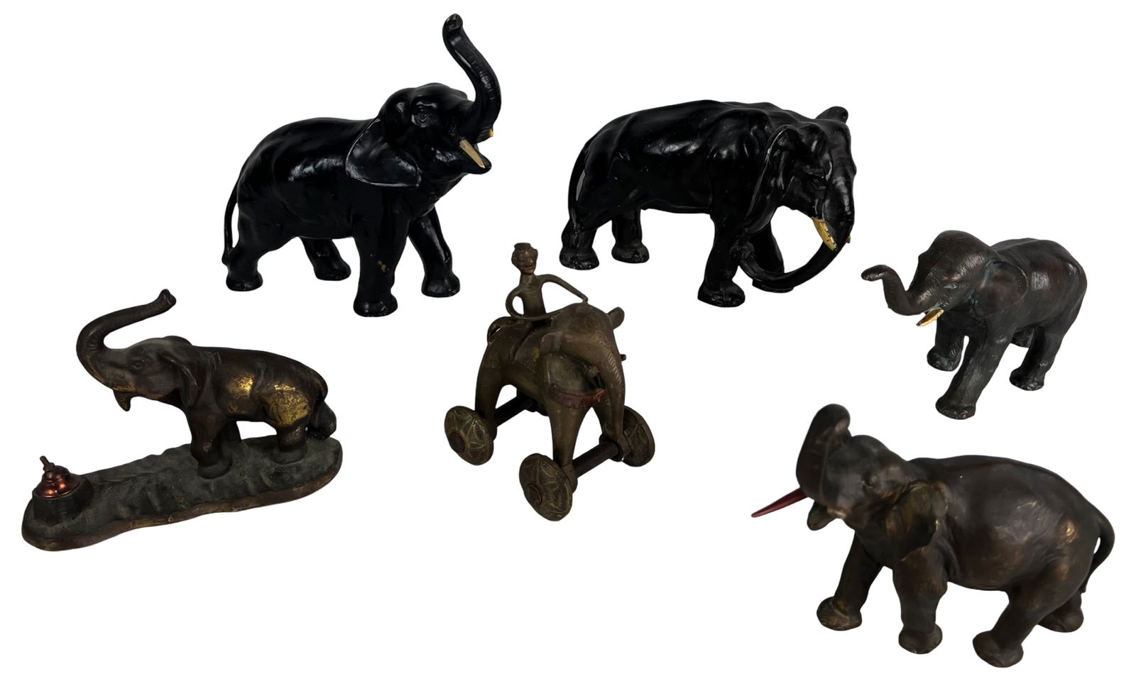 Antique and Vintage Cast Metal Elephant Figurines: Group of antique and vintage cast metal elephant figures, including larger black-finished elephant statuettes with applied tusks and smaller patinated metal examples. The lot also features an antique