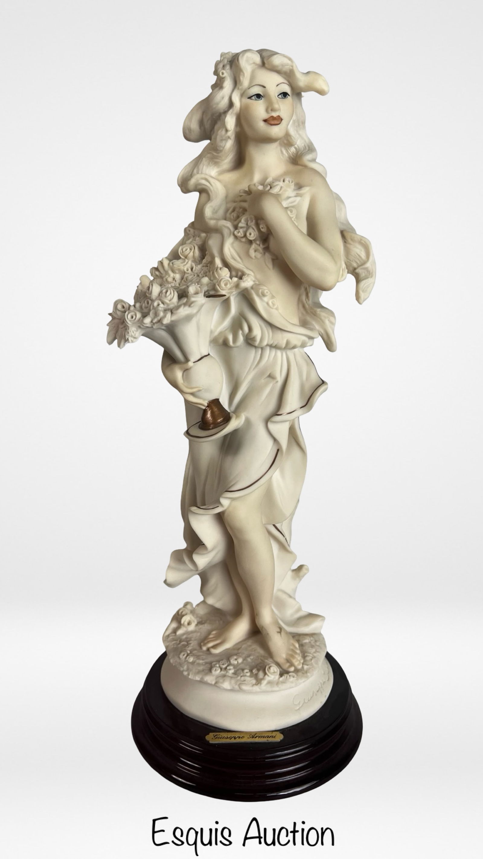 Giuseppe Armani Spring - Lady with Flowers Basket: Elegant porcelain figurine titled "Spring - Lady with Flowers Basket" designed by renowned Italian sculptor Giuseppe Armani. The sculpture depicts a graceful young woman draped in flowing garments,