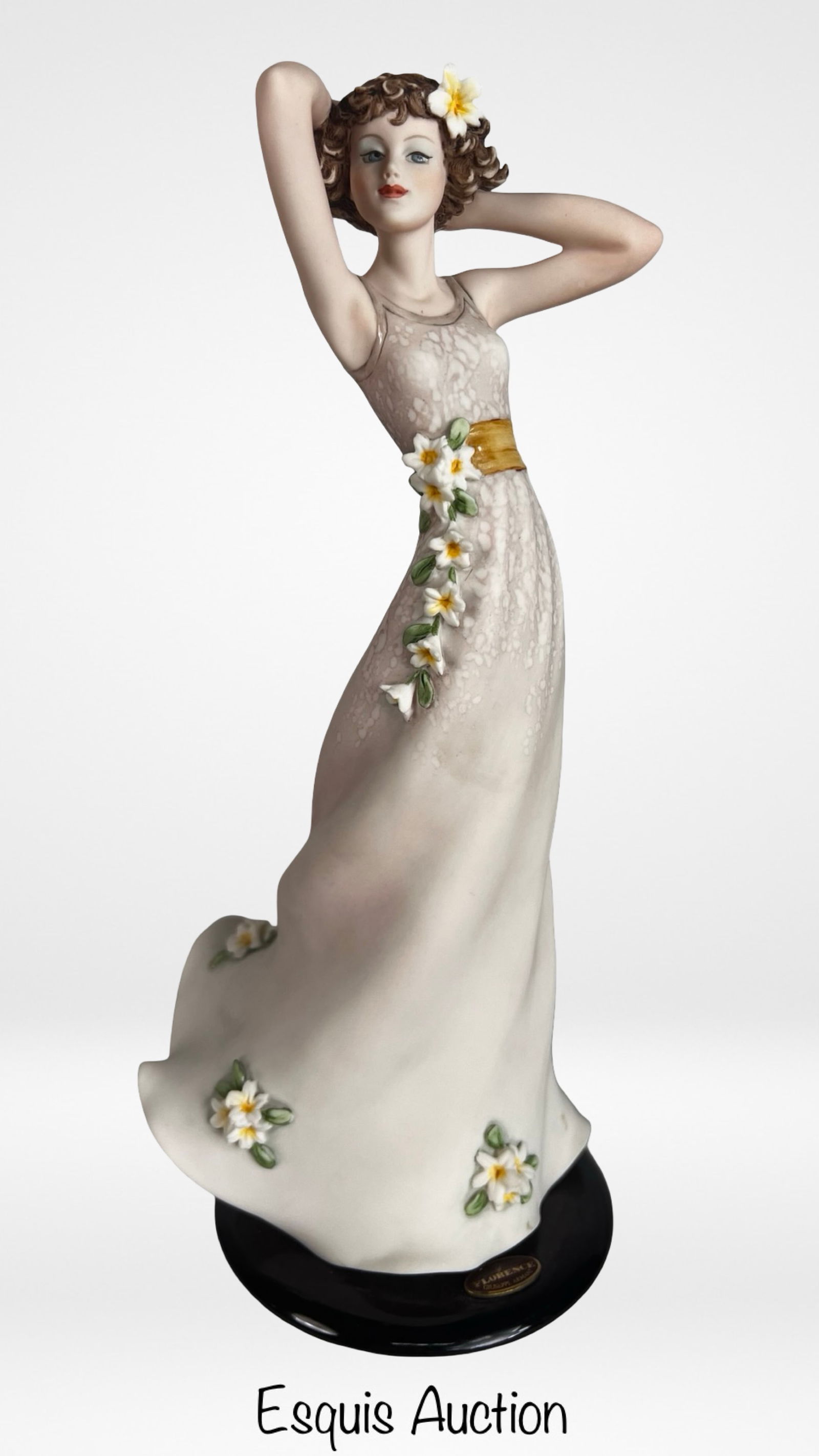 Giuseppe Armani "Spring Breeze" Figurine: Graceful porcelain figurine titled "Spring Breeze" designed by celebrated Italian sculptor Giuseppe Armani. The sculpture portrays a young woman in a flowing dress adorned with delicate blossoms, capt
