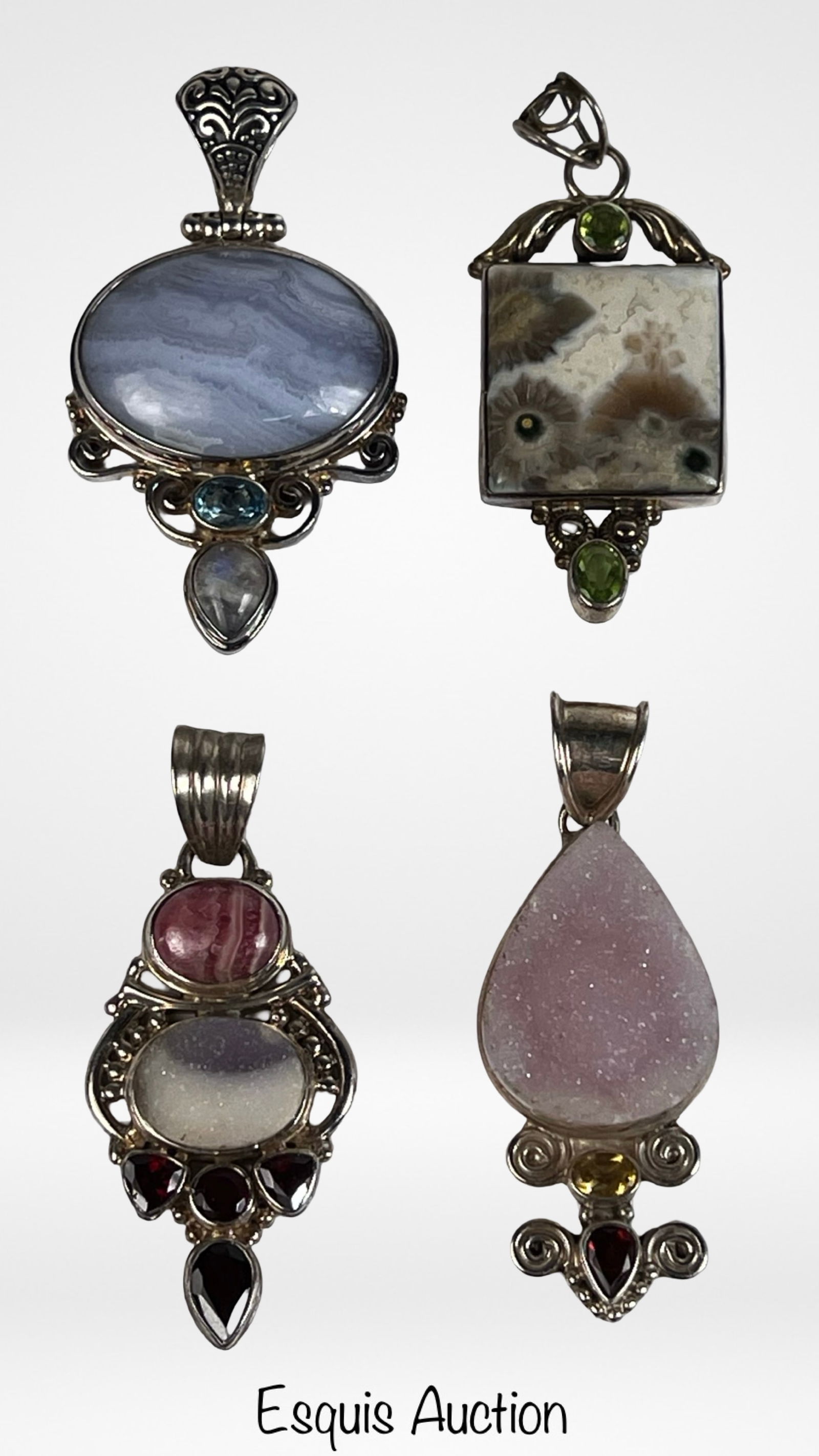 Statement Sterling Silver Multi Stone Pendants: Striking group of four large sterling silver pendants, each featuring bold natural stone compositions in ornate settings. Designs include an oval blue banded agate style stone with accent stones, a