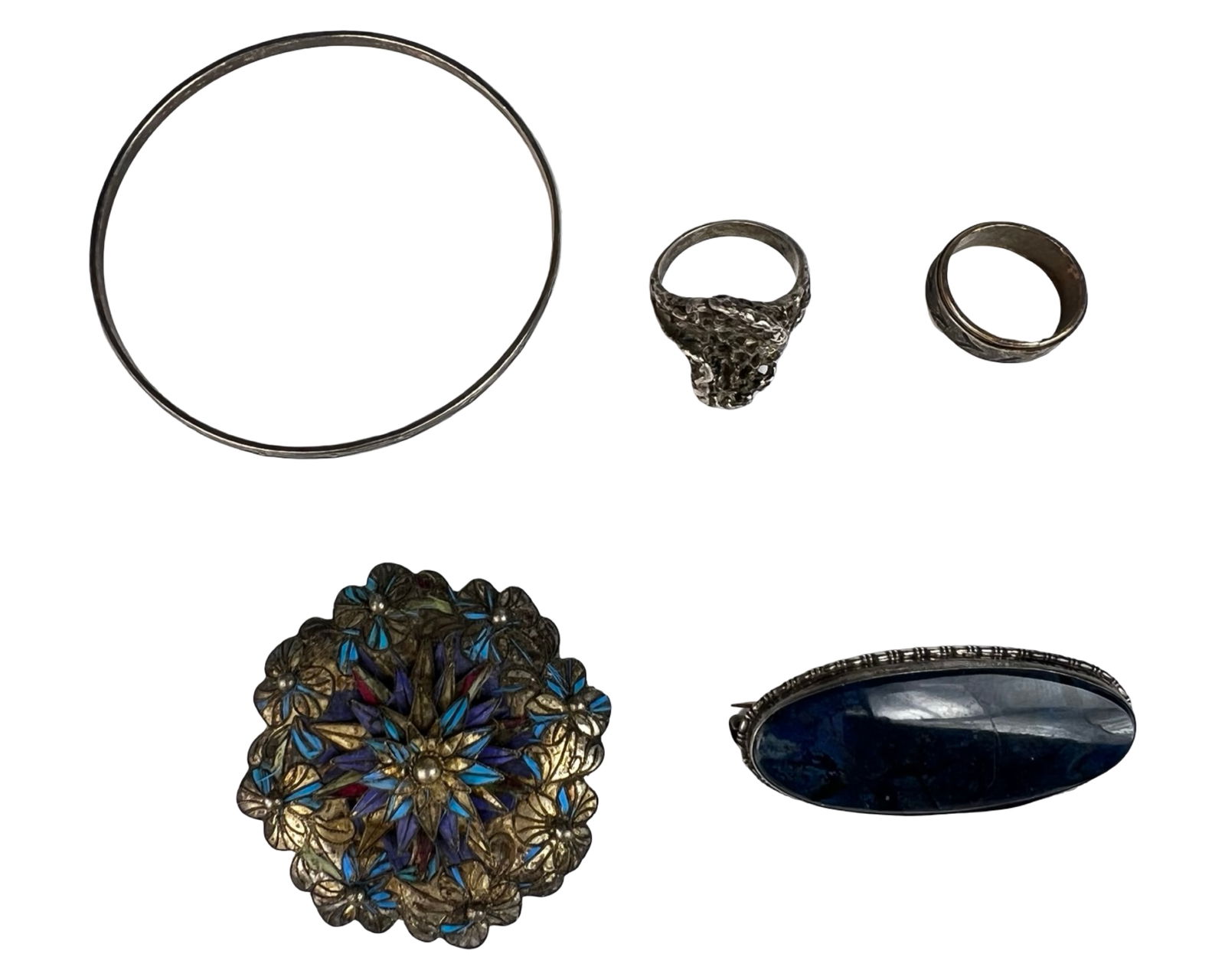 Sterling Silver Jewelry - Bracelet. Rings. Brooch: Mixed group of sterling silver jewelry including a simple bangle bracelet, two rings, and two brooches. The bracelet features a clean, minimalist circular form, while the rings include a textured