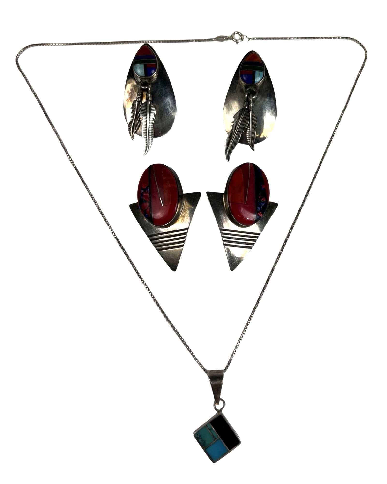 Native American Sterling Silver Jewelry Ray Tracey: Striking group of Native American sterling silver jewelry featuring a signed Ray Tracey pendant necklace and two pairs of bold statement earrings. The necklace showcases a geometric inlay pendant set