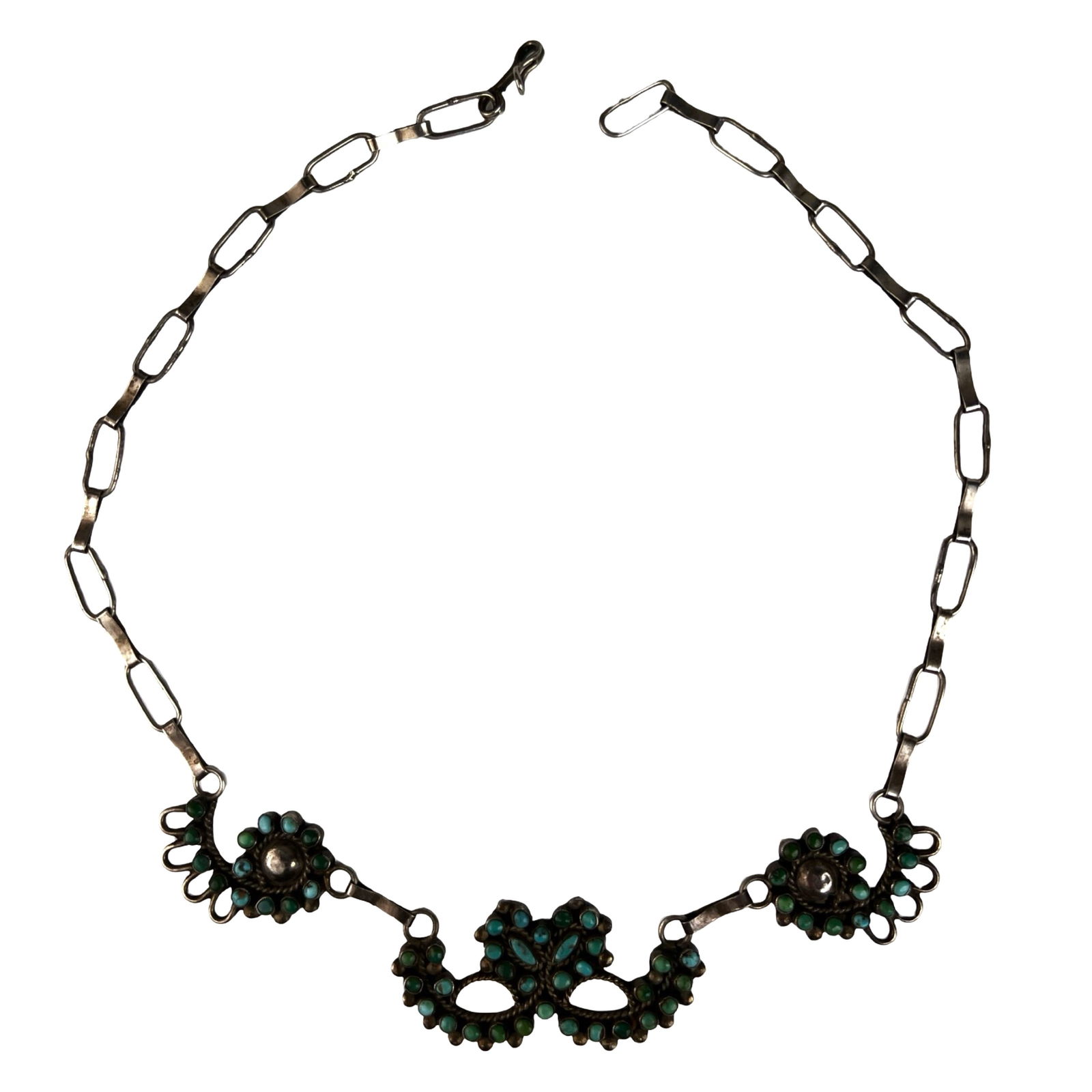 Vintage Zuni Sterling Silver Turquoise Necklace: Classic vintage Zuni sterling silver necklace featuring finely set turquoise stones in a traditional petit point style arrangement. The centerpiece displays a symmetrical, mask like motif with