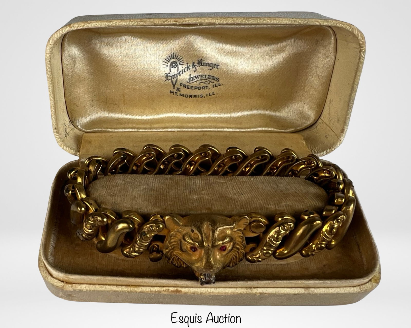Victorian Gold Filled Repousse Lion Head Bracelet: Striking Victorian-era gold filled bracelet featuring bold, dimensional repoussé links and a prominent lion head motif adorned with vivid red stone eyes. The lion's head serves as a decorative