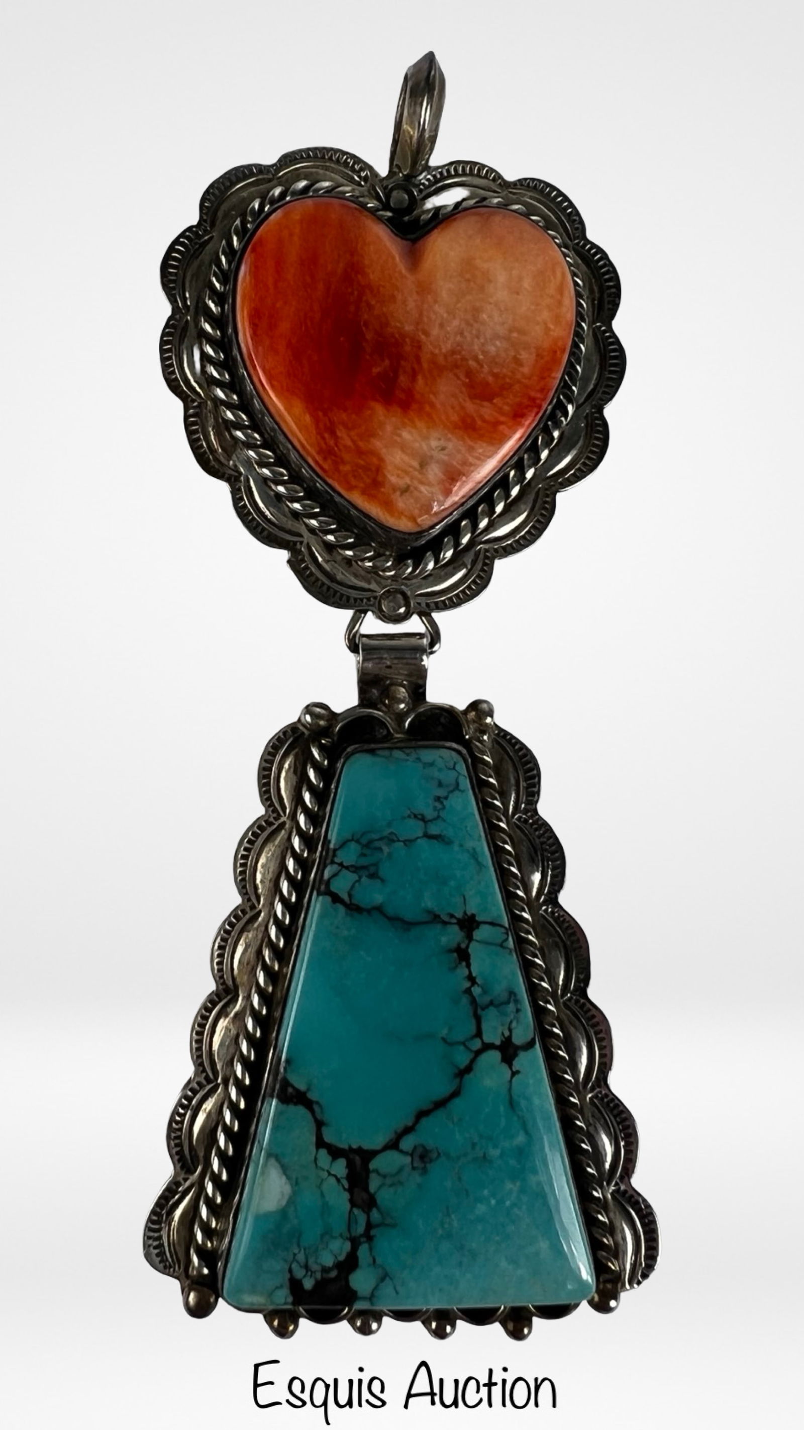Irv Monte Navajo Sterling Oyster Heart Pendant: Bold Navajo sterling silver pendant by Irv Monte, showcasing a striking two-stone composition. The upper section features a heart-shaped spiny oyster shell in warm orange hues, set within a scalloped