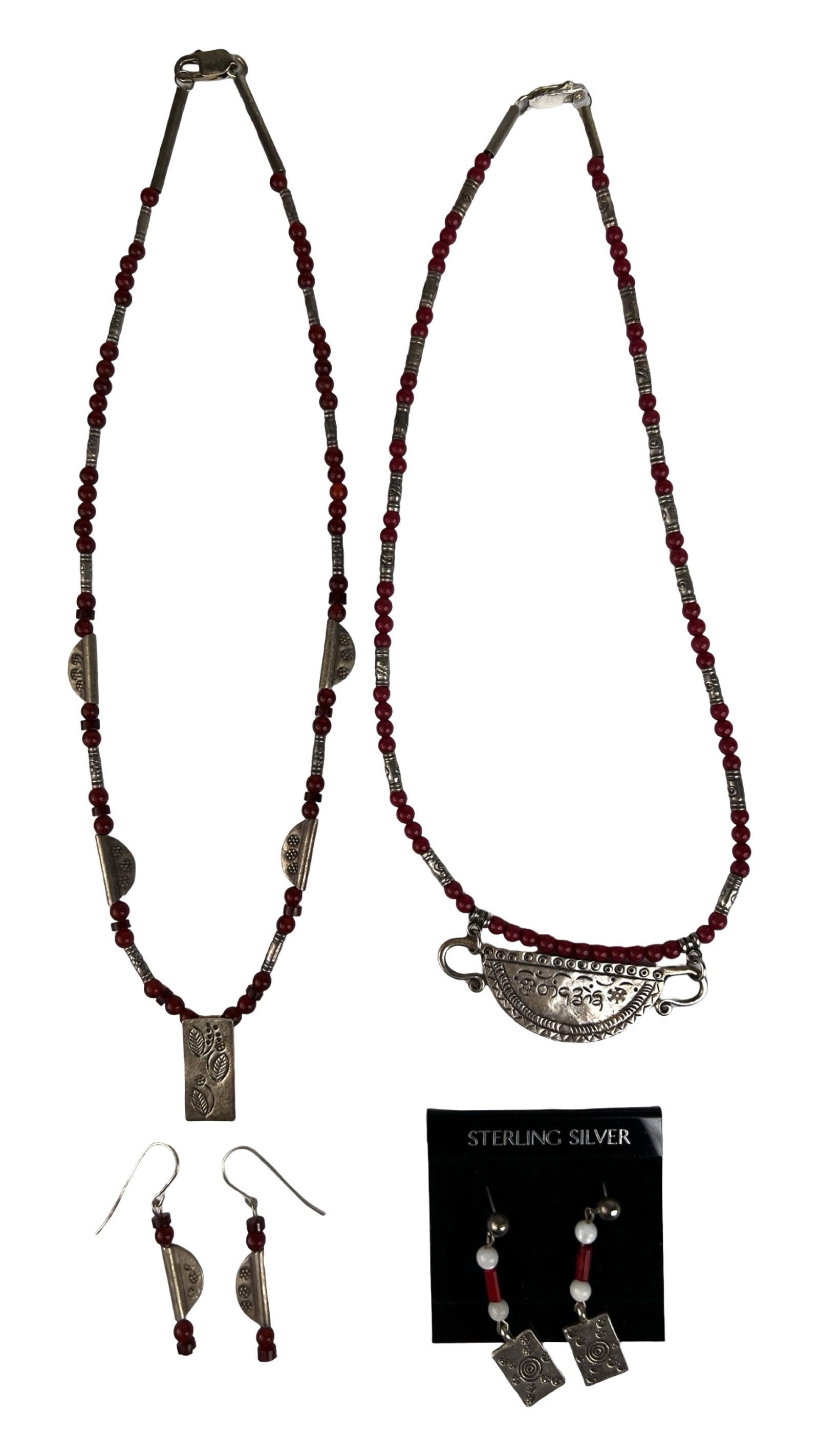 Sterling Silver Red Bead Necklaces w Earrings: Decorative grouping of sterling silver jewelry featuring two beaded necklaces with coordinating earring pairs. Each necklace is composed of red beads accented with silver spacers and stamped