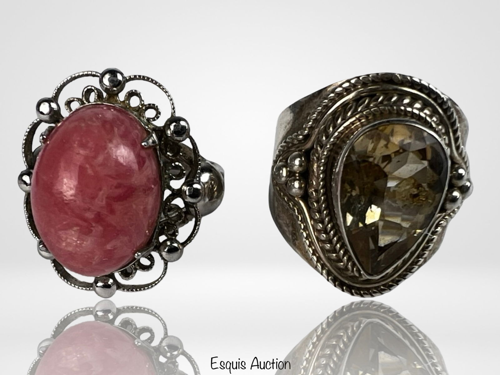 Sterling Silver Rhodochrosite & Smoky Quartz Rings: Pair of sterling silver rings featuring two distinct gemstone styles. One ring showcases a polished oval rhodochrosite cabochon in a decorative openwork setting with bead accents, offering a bold and