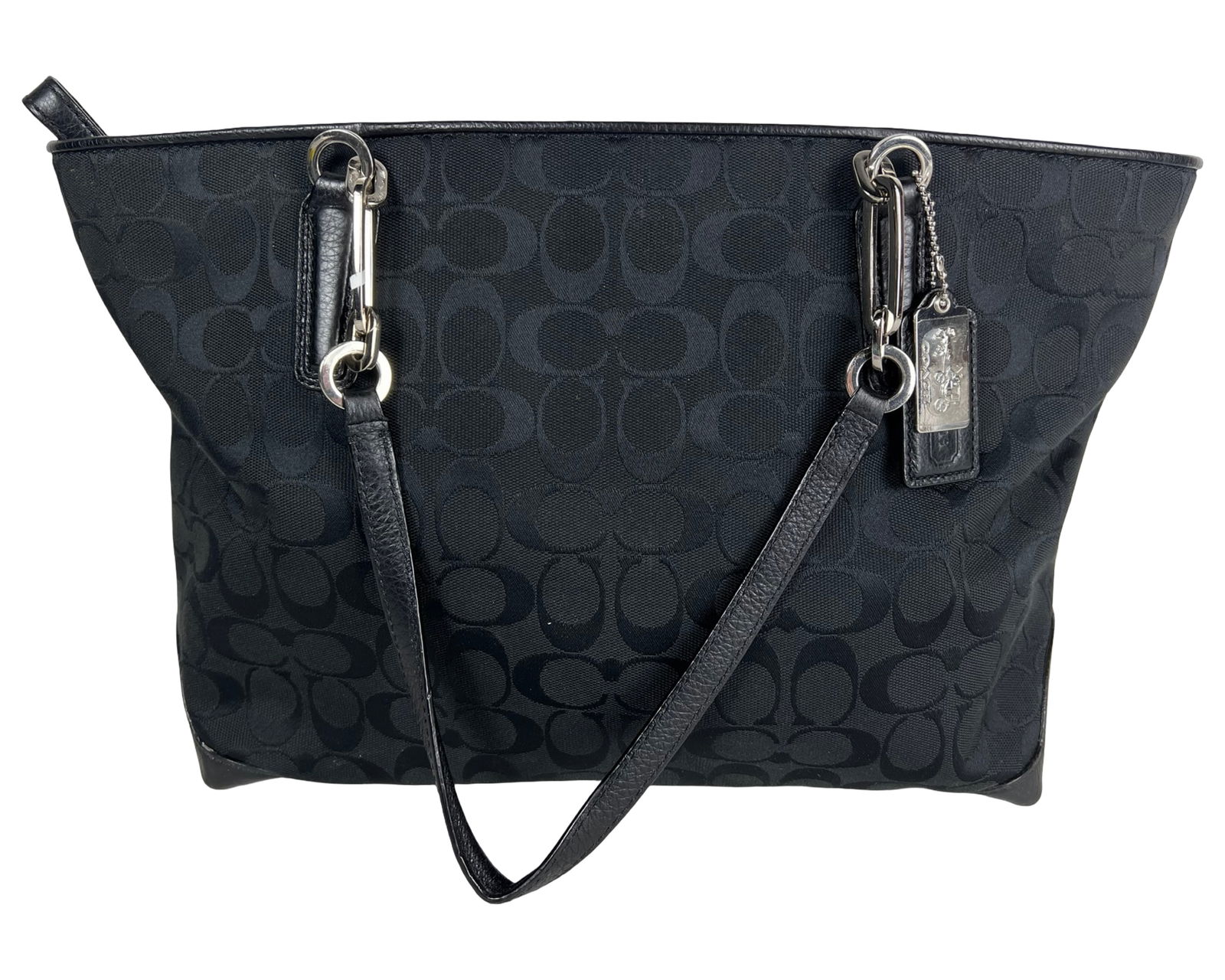 Coach Signature Jacquard Canvas Tote Bag: Classic tote bag crafted in the brand's signature jacquard canvas featuring the iconic tonal monogram pattern throughout. Designed with black leather trim and dual shoulder straps, accented by