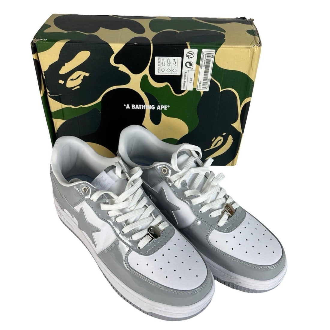 Bathing Ape Bape Sta Patent Leather Sneakers: Bathing Ape Bape Sta sneakers in white and grey patent leather. Comes with the original camouflage box. Clean, glossy finish with crisp star detailing and immaculate soles. Size 10.5.Mint.