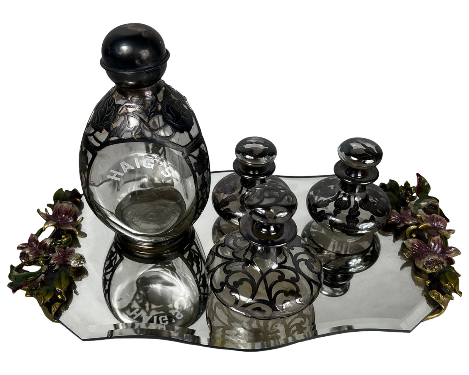 Sterling Silver Overlay Bottle & Perfume Bottles: Vintage 1940s Haig's "Pinch" Scotch whiskey bottle featuring an elegant sterling silver overlay with intricate filigree decoration and original form. The glass body is etched "Haig's," and the piece r