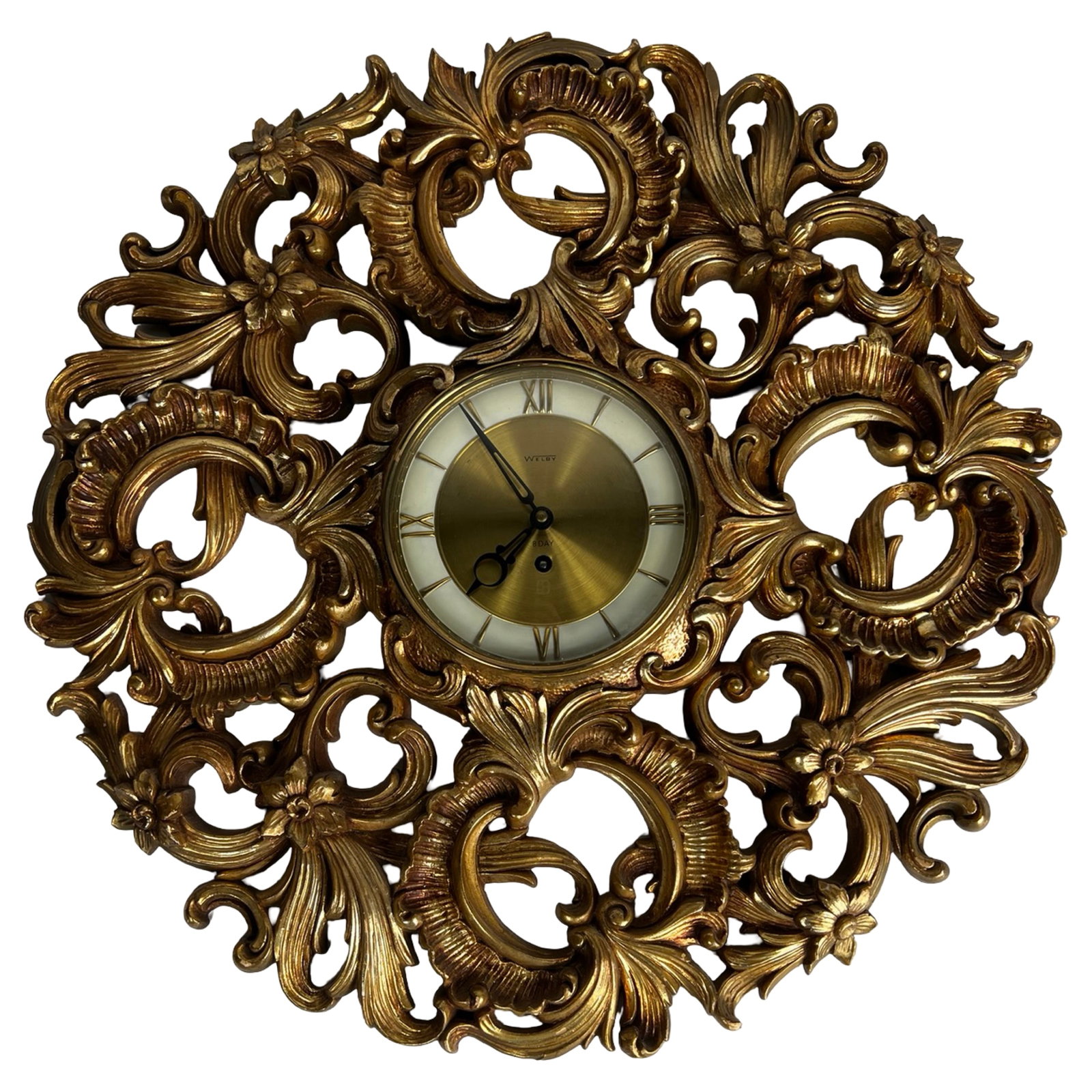 Welby 8 Day Wall Clock Gilt Rococo Style Syroco: Mid-century Welby wall clock featuring an elaborate Rococo-style frame with richly detailed scrolling acanthus and floral motifs in a gilt finish. The ornate openwork design is characteristic of Syroc
