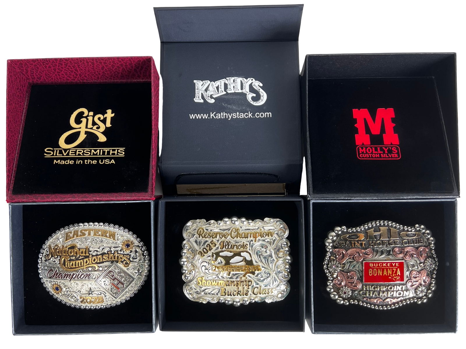 Eastern National Championship Trophy Belt Buckles: The collection features highly detailed, multi-tone engraved designs with raised lettering and decorative borders. Highlights include an "Eastern National Championships Champion 2025" buckle by Gist,