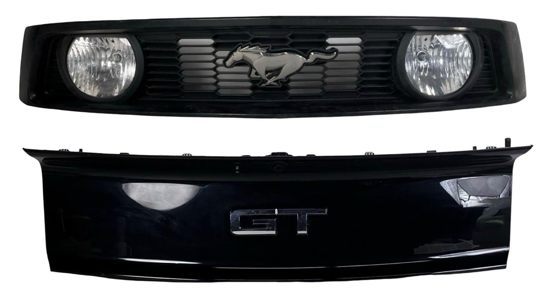 2005-2009 Ford Mustang GT Upper Grille & Trunk Lid: OEM exterior components for a 2005-2009 Ford Mustang GT, consisting of the upper front grille and rear trunk lid panel. The grille features the iconic running horse emblem flanked by integrated fog li