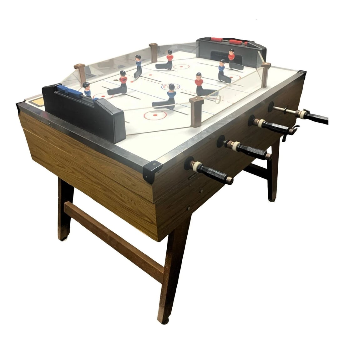 Vintage Coin Operated Tabletop Arcade Hockey Game: Vintage coin operated tabletop hockey game featuring classic arcade style mechanical gameplay with hand operated rods controlling players. Designed for two or four players, this nostalgic game offers