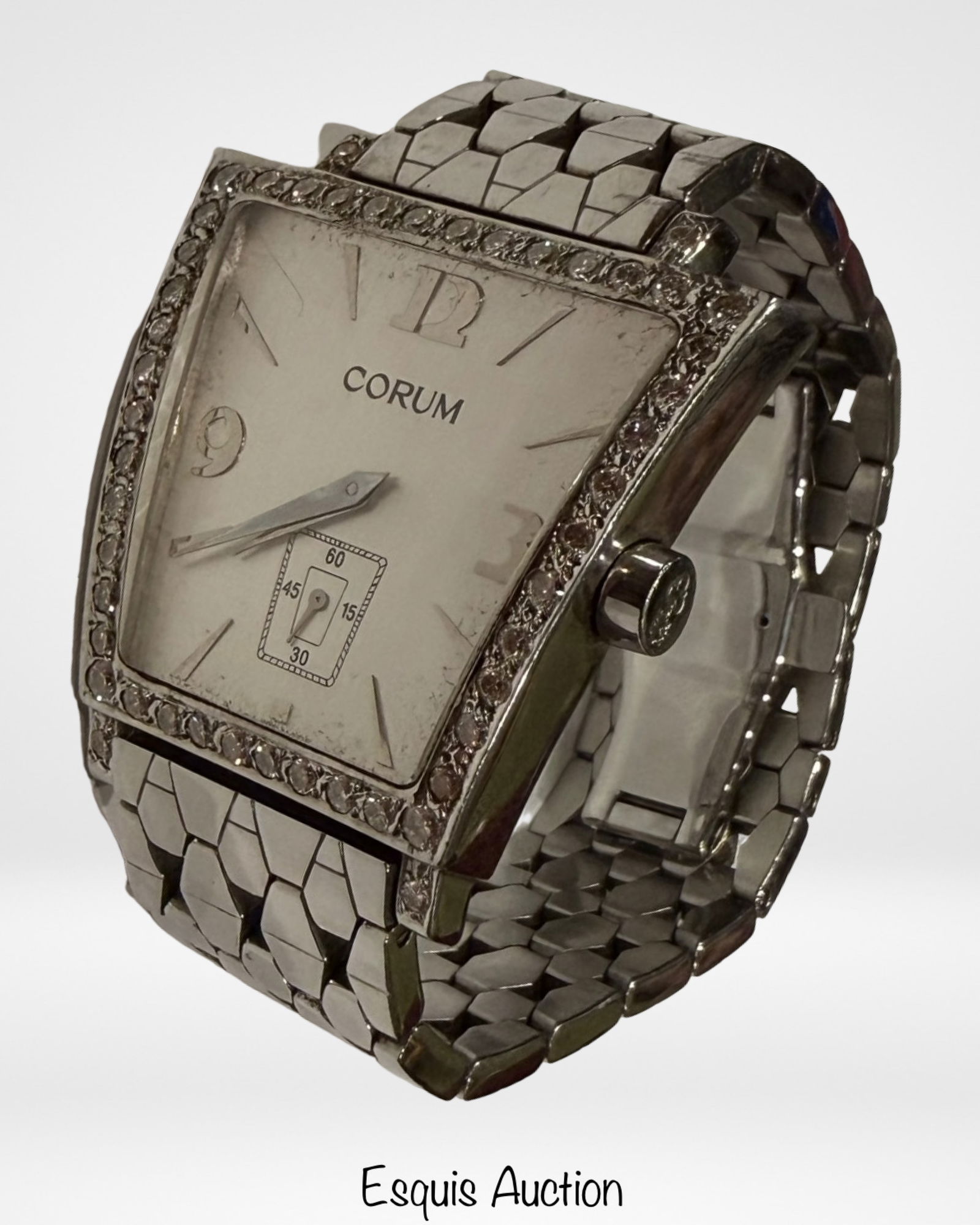 Corum Trapeze Diamond Bezel Watch: Corum Trapeze wristwatch in stainless steel featuring the distinctive curved case design on original bracelet. Diamond-set bezel frames a dial with applied Arabic numerals, baton hour markers, and sma