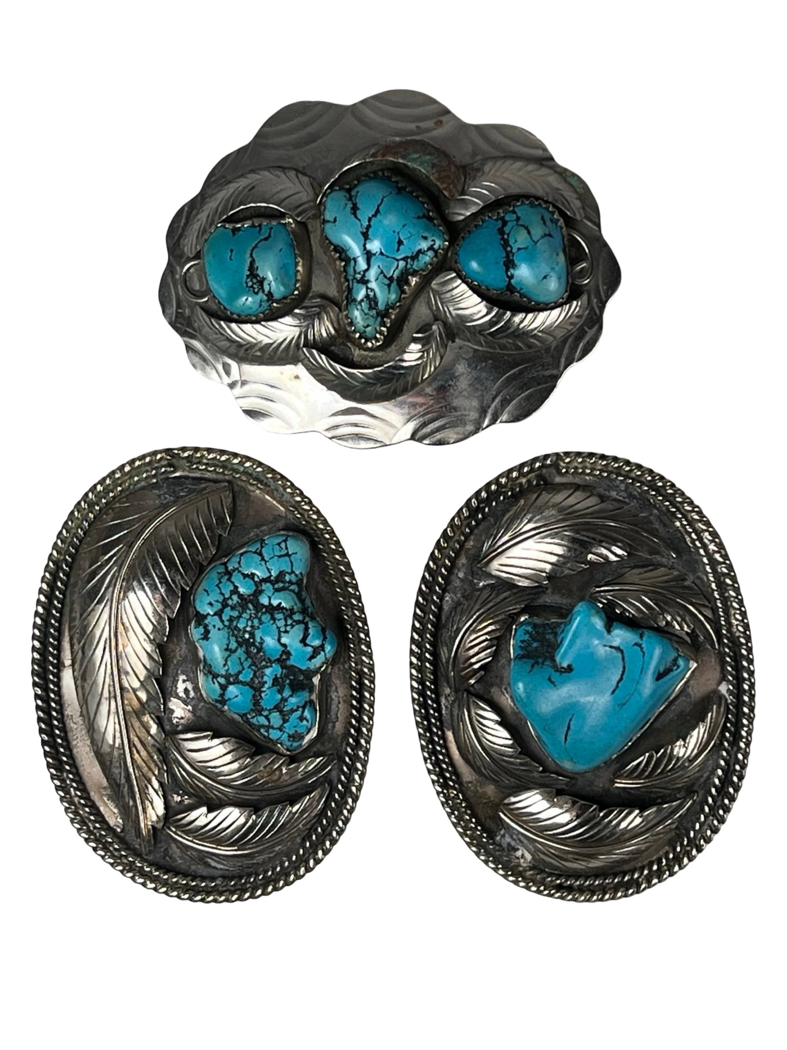 Vintage Southwest Stone Inlay Belt Buckles: Collection of three vintage Southwest belt buckles featuring bold stone settings in handcrafted designs. Each piece showcases unique organic shapes complemented by detailed feather and textured