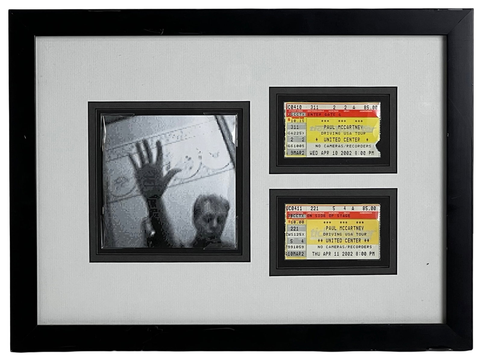 Paul McCartney Driving USA Tour '02 Ticket Display: Framed memorabilia display featuring two original concert tickets from Paul McCartney's Driving USA Tour at the United Center in April 2002. The presentation includes tickets for both April 10 and