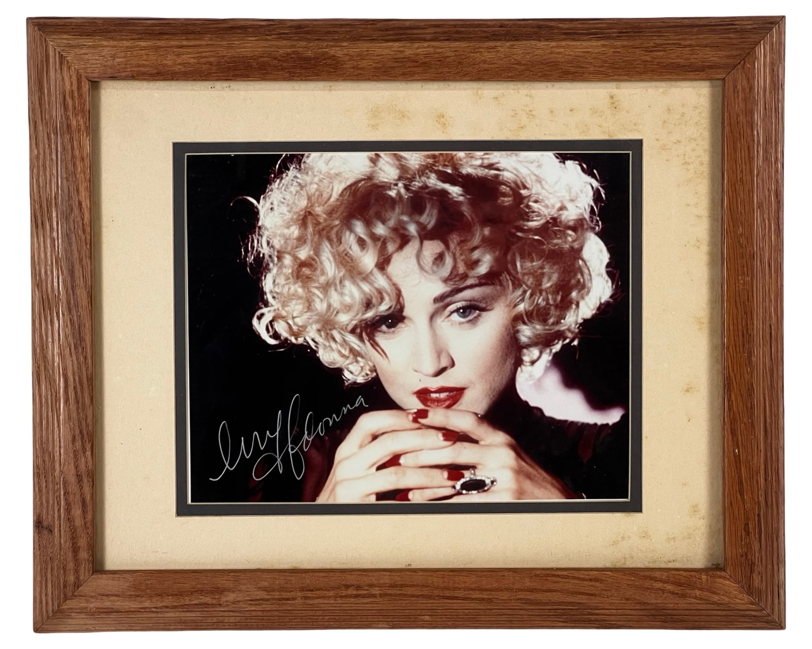 Madonna Autographed Photograph - Pop Icon Portrait: Striking autographed photograph of pop music icon Madonna, featuring a bold signature across the image. The portrait captures her signature platinum blonde curls and unmistakable style, making it an e
