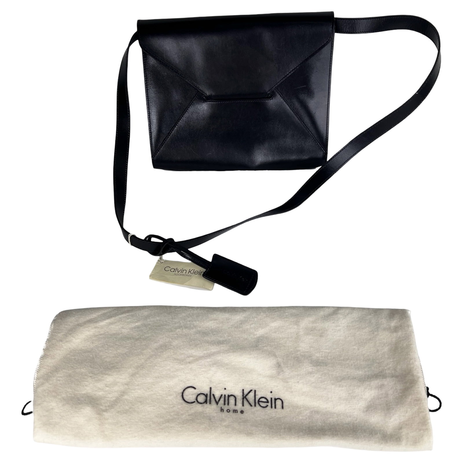 Calvin Klein Leather Crossbody Minimalist Bag: Sleek Calvin Klein crossbody bag crafted in smooth black leather, featuring a clean, structured silhouette with modern geometric panel detailing on the front flap. The minimalist design is complemente