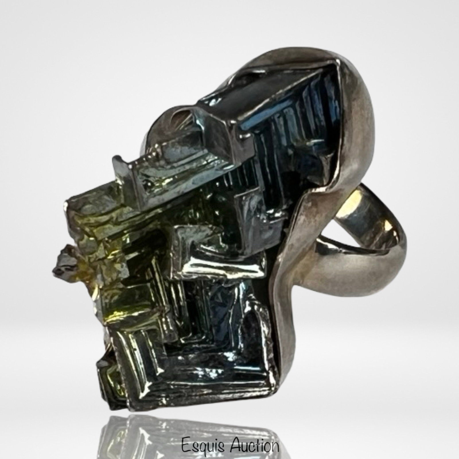 Sterling Silver Iridescent Bismuth Crystal Ring: Striking sterling silver ring featuring a natural bismuth crystal with its signature stepped, geometric formation and iridescent metallic tones ranging from steel gray to hints of gold and green. The 