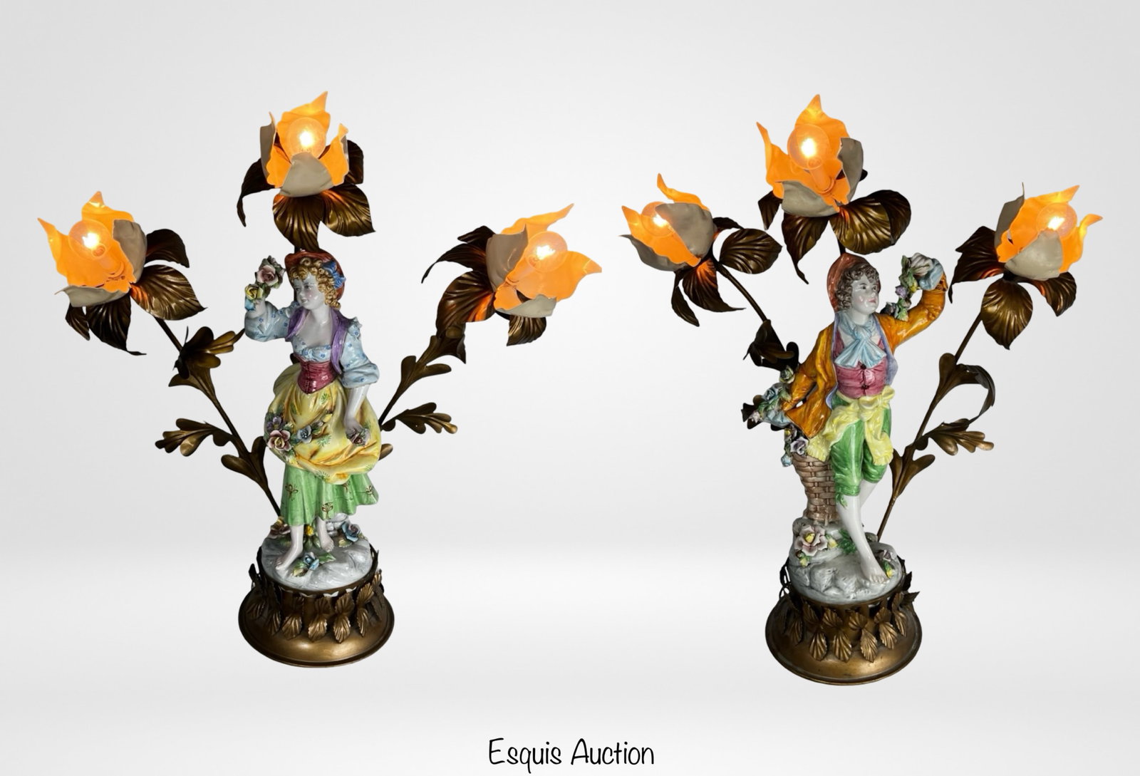 Capodimonte Porcelain Figural Floral Tole Lamps: Impressive pair of large Capodimonte porcelain figural lamps featuring finely modeled male and female figures in classical pastoral attire, each surrounded by elaborate gilt tole floral branches. The 