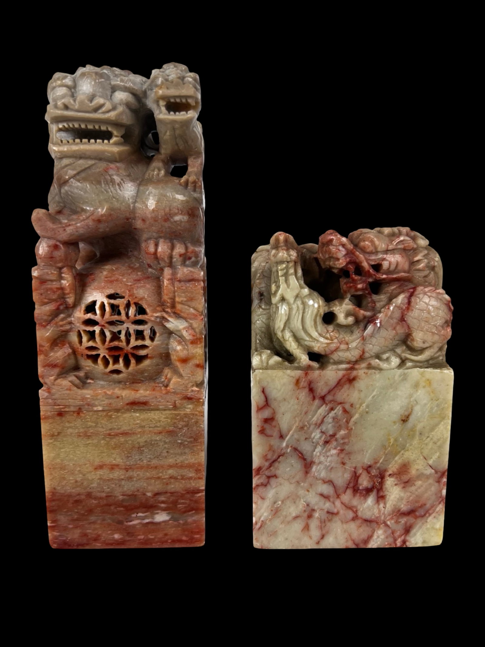 Chinese Carved Hardstone Seal Chops- Foo Lion Dra: Pair of Chinese carved hardstone seal chops, each surmounted by finely detailed mythological creatures including a foo lion and dragon. The stones display attractive natural veining in cream and reddi