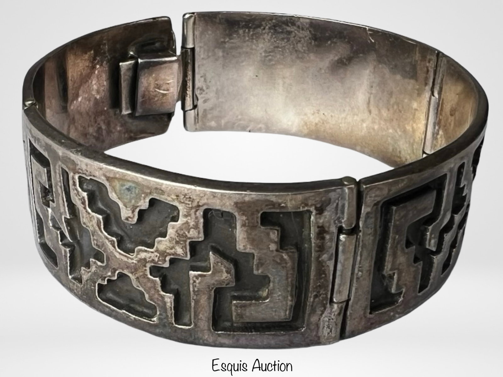 Massive Taxco Sterling Silver Panel Bracelet: Vintage Taxco sterling silver hinged panel bracelet featuring a bold geometric motif with cut-out design elements. The bracelet is constructed with articulated panels and a secure box clasp, offering 
