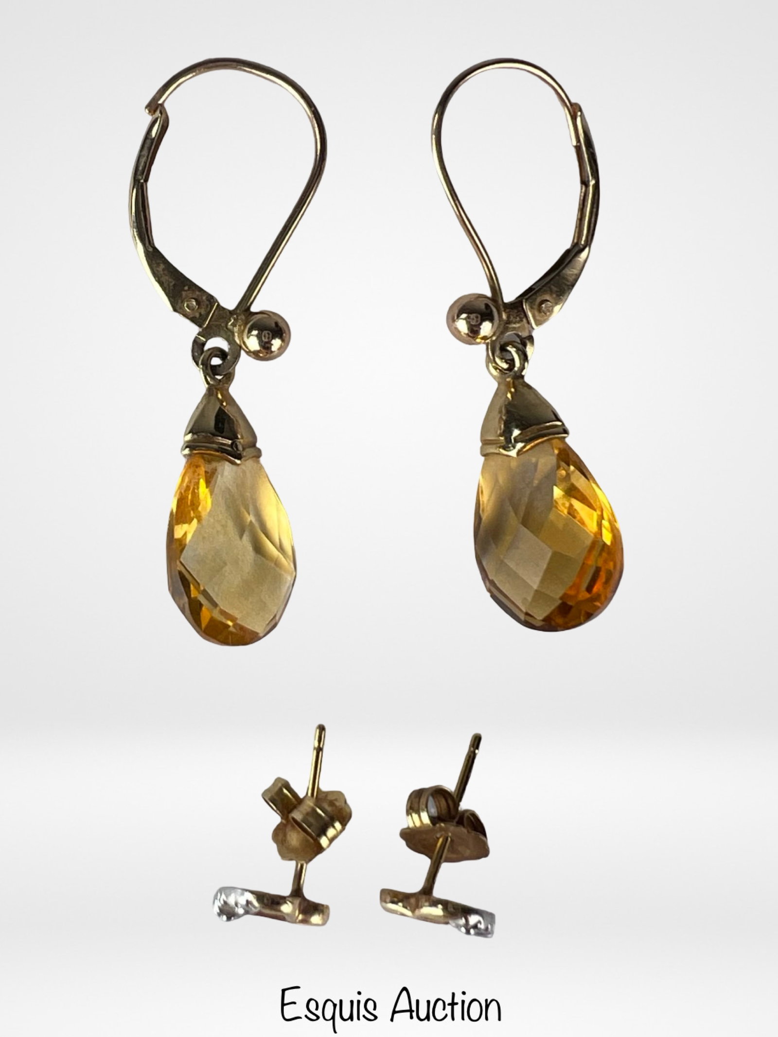 14k & 10k Gold Earrings- Citrine Dangles & Heart: Two pairs of fine gold earrings. The first pair features 10K yellow gold dangle earrings set with pear-shaped faceted citrine stones, finished with secure lever back closures. The citrine shows a rich