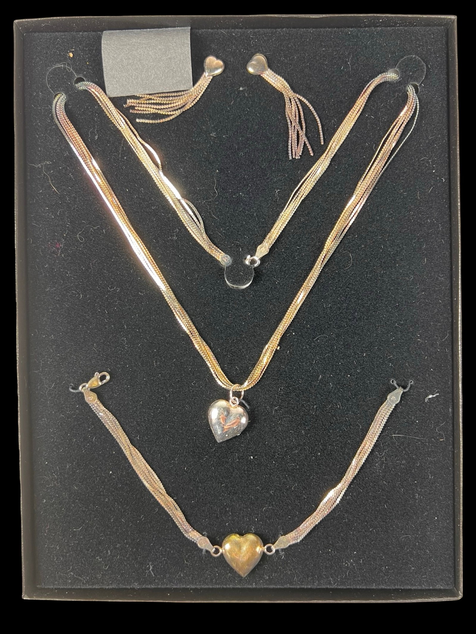 Sterling Silver Heart Jewelry Set Necklace Bracele: Coordinated sterling silver jewelry set featuring a heart motif throughout. Includes a multi-strand necklace with heart pendant, matching bracelet with heart centerpiece, and a pair of tassel drop