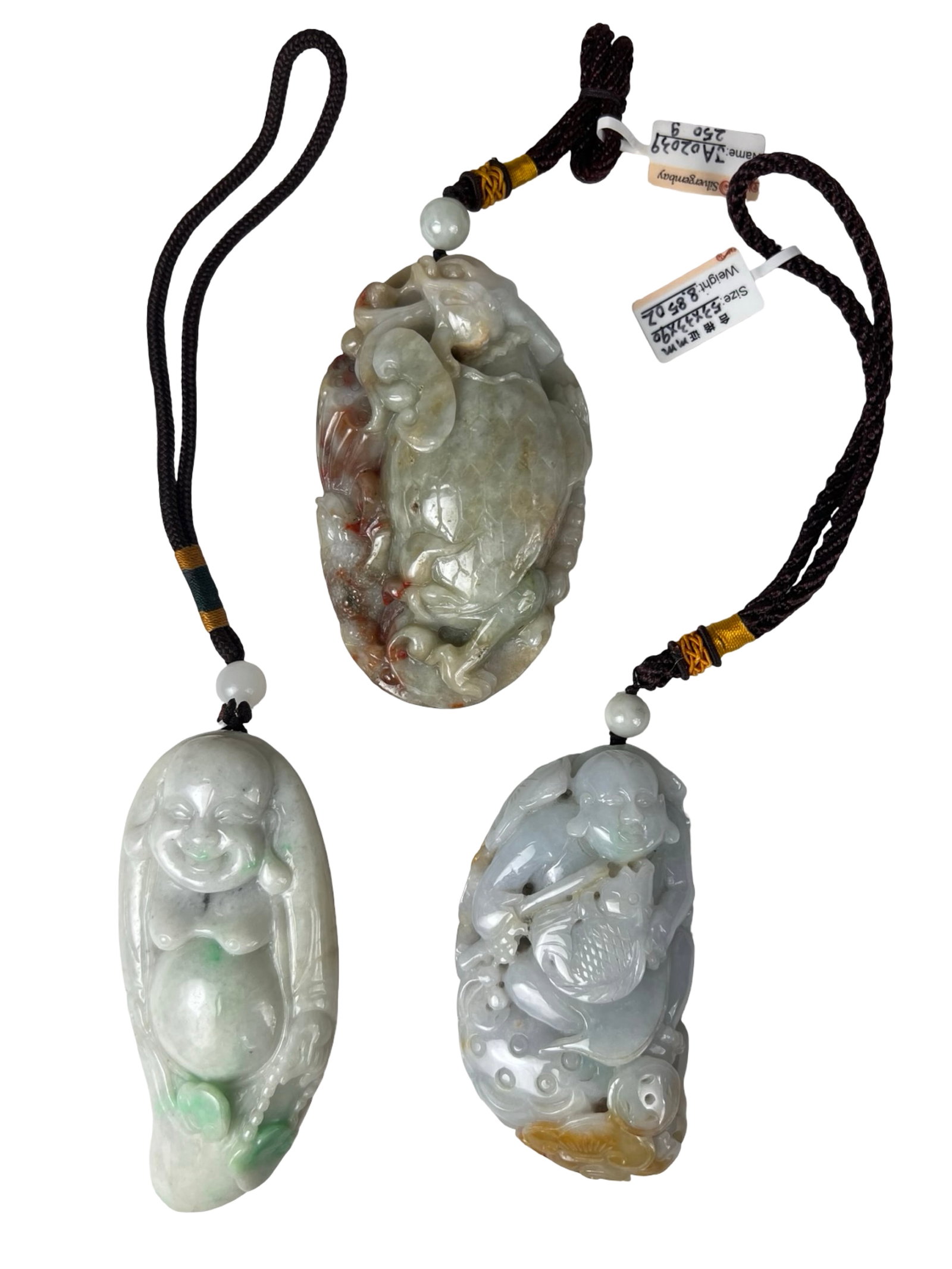 Group of 3 Carved Jade Hand Held Pendant Figures: Group of three carved jade pendants, each suspended on cord with bead accents. The carvings include a figural form, a fruit or gourd motif, and a detailed scene featuring a figure with fish and