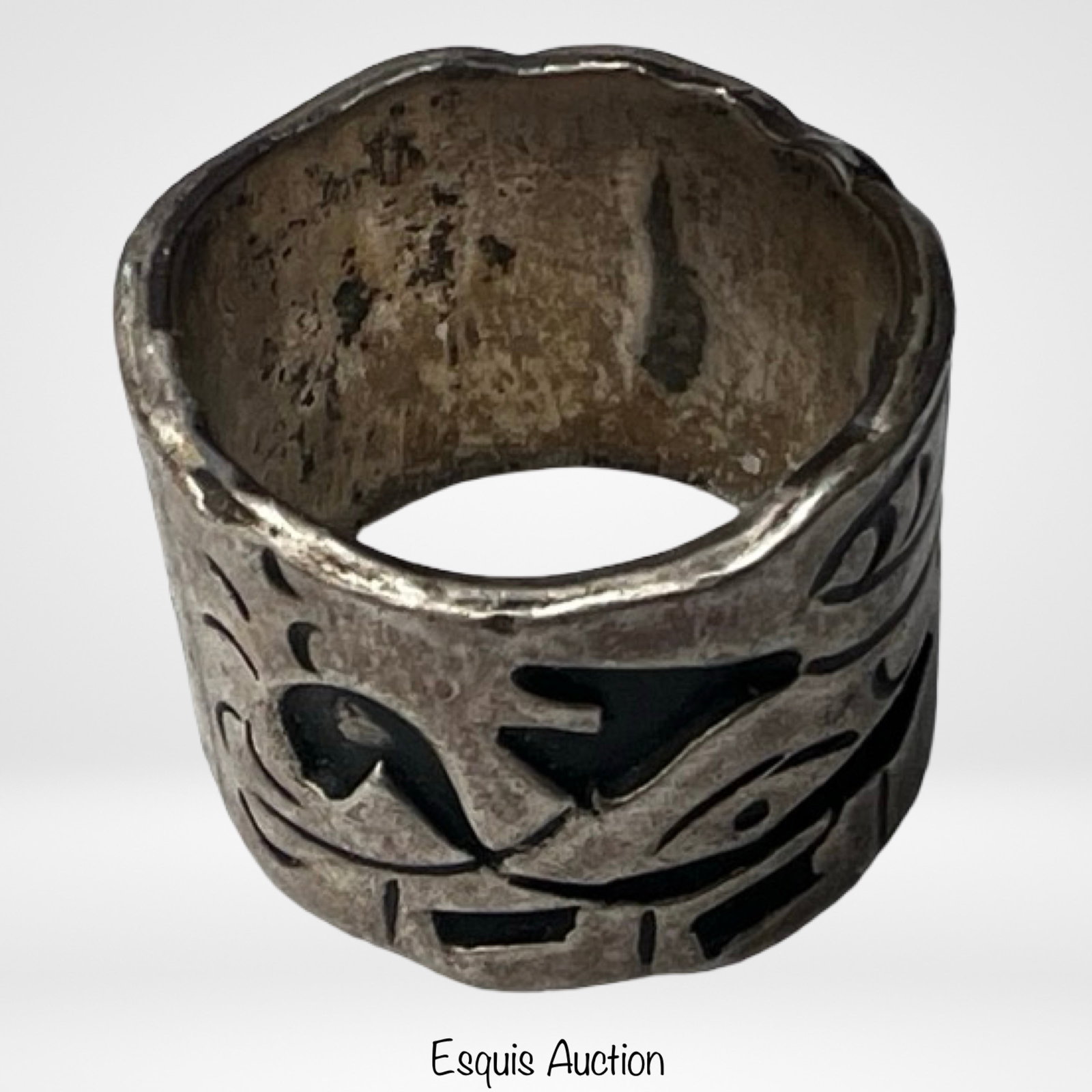 Vintage Taxco Sterling Silver Wide Band Ring: Striking vintage Taxco sterling silver band ring featuring a wide profile with bold abstract cutout motifs and darkened background for contrast. The design showcases a sculptural, almost modernist aes