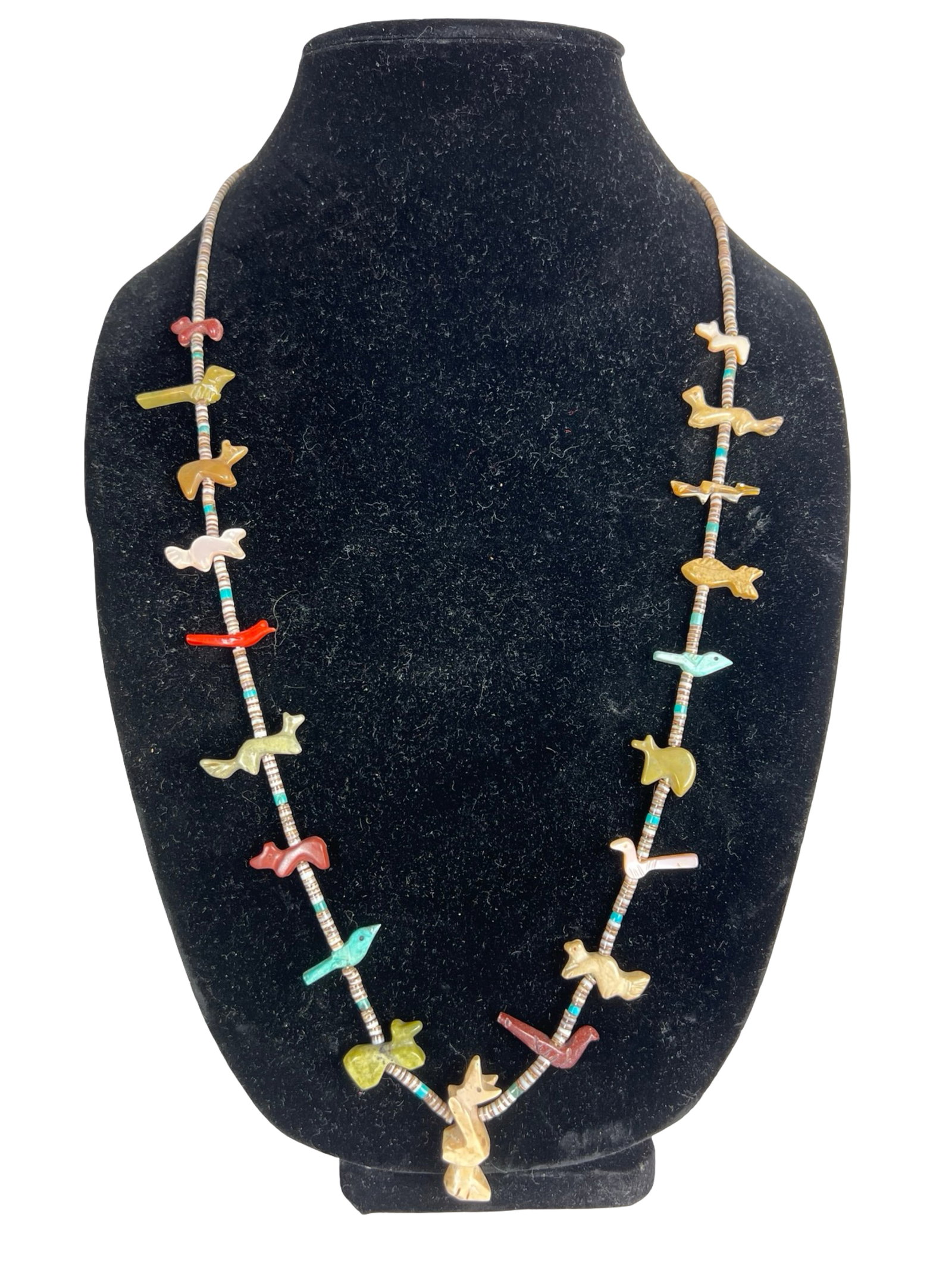 Zuni Fetish Necklace Hand Carved Stone Animals: Vintage Zuni Native American fetish necklace featuring a striking arrangement of hand-carved stone animals and birds, each individually shaped and strung along traditional heishi shell beads. The figu