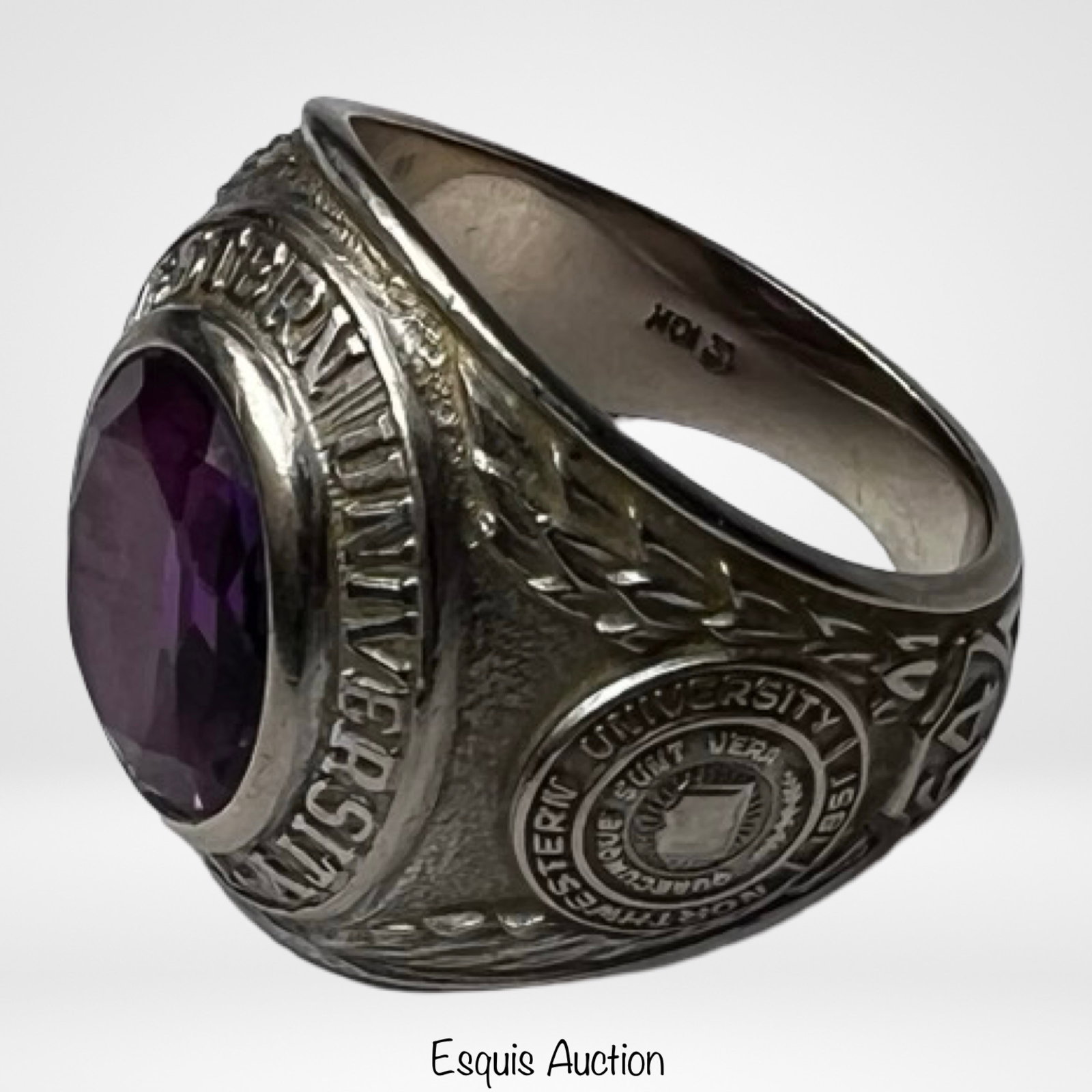 10k Massive Gold Northwestern University Ring: Vintage 10k gold class ring from Northwestern University, dated 1964, featuring a large oval faceted purple stone set in a bold, traditional setting. The bezel is engraved "Northwestern University 185