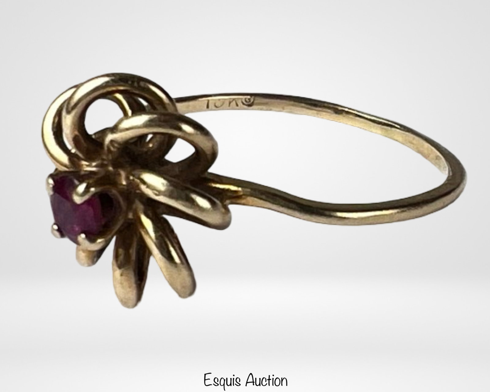 10k Gold Vermeil Ruby Ring Floral Knot Design: Elegant 10k gold vermeil ring featuring a rich red ruby set at the center of an intricate openwork floral knot design. The sculptural looping motif creates a soft, dimensional look, giving the piece a