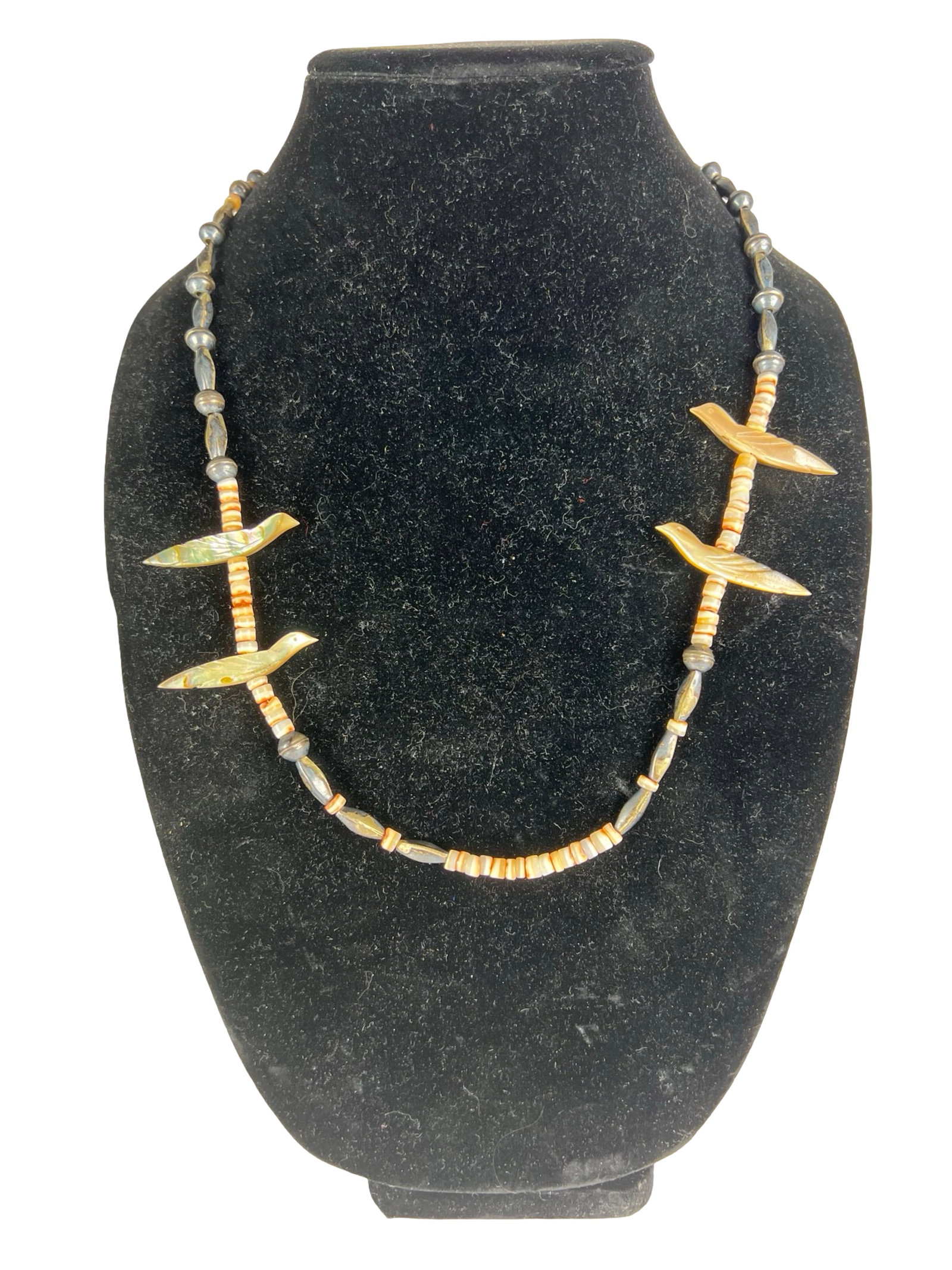 Zuni Native American Bird Fetish Necklace: Striking Zuni Native American fetish necklace featuring finely carved mother-of-pearl birds, each symbolically representing protection and guidance. The birds are beautifully spaced along strands of