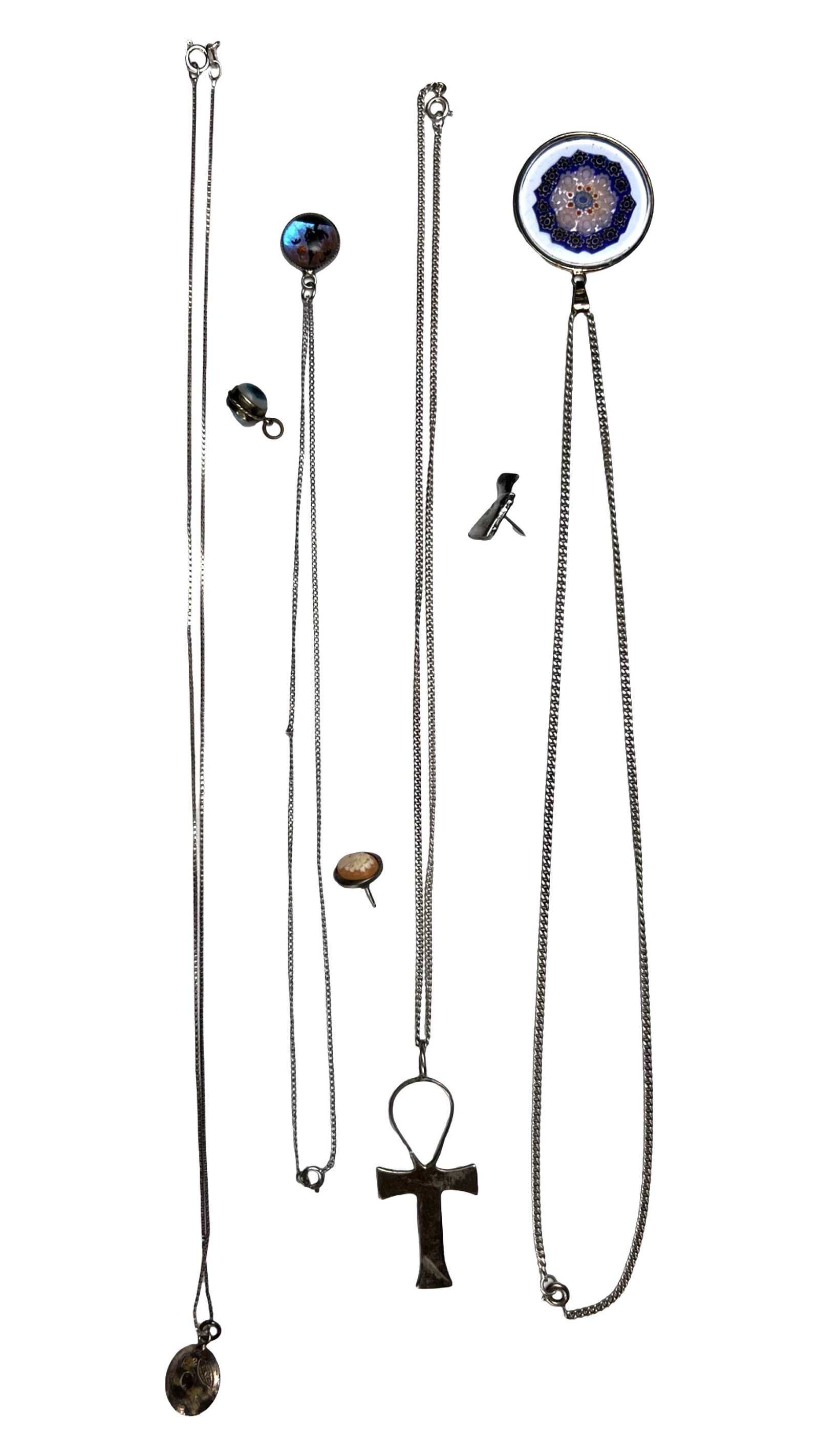 Assorted Sterling Silver Necklaces & Pendants: Group of assorted sterling silver necklaces , pins and pendants featuring a variety of styles and motifs. The lot includes a carved shell cameo lapel pin, a figural Queen Cleopatra lapel pin, a millef