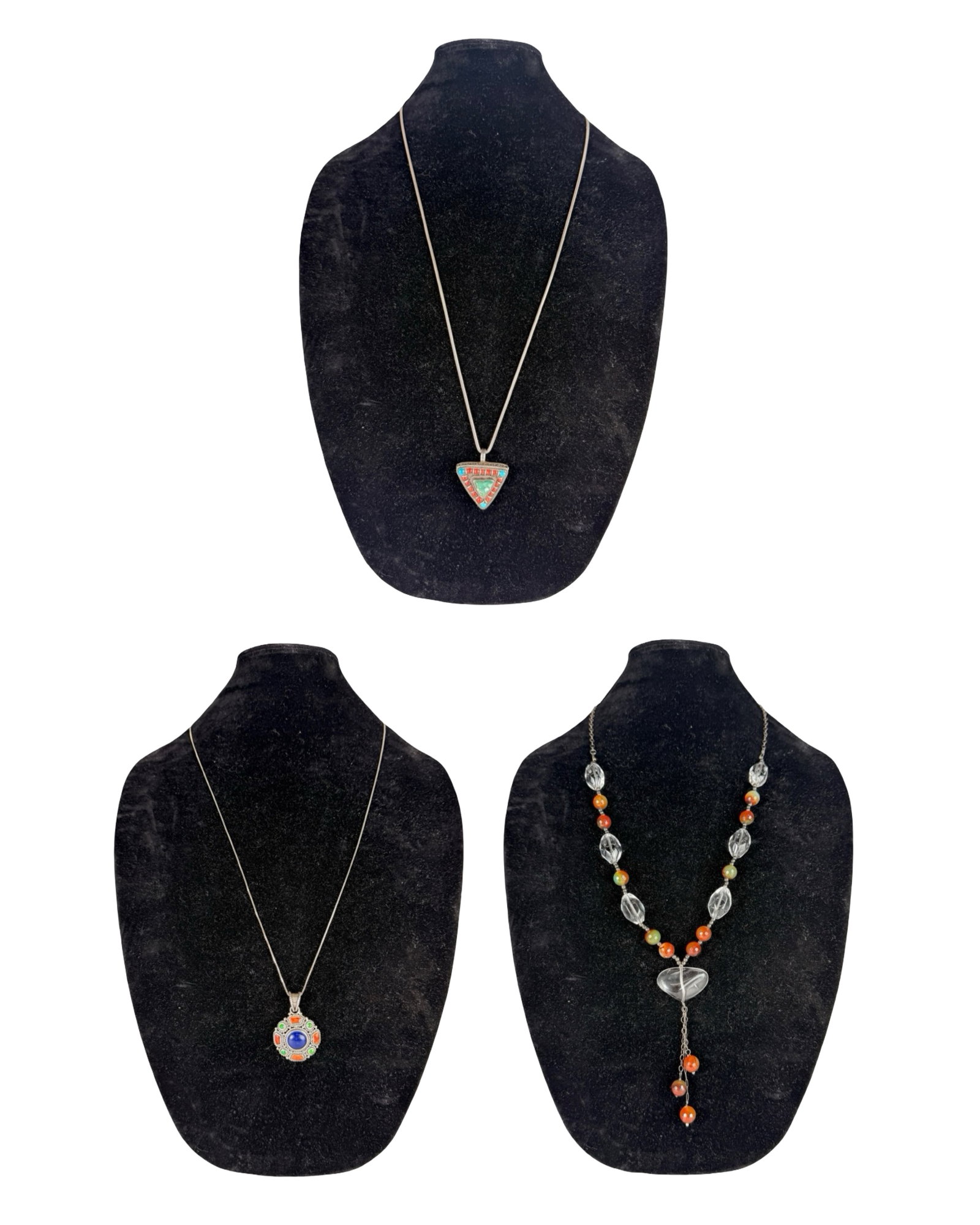 Group of Sterling Silver Necklaces with Pendants: Group of three sterling silver necklaces featuring distinctive pendant designs. Includes a triangular pendant necklace with turquoise and coral-style stone accents in a Tibetan or Nepalese-inspired se