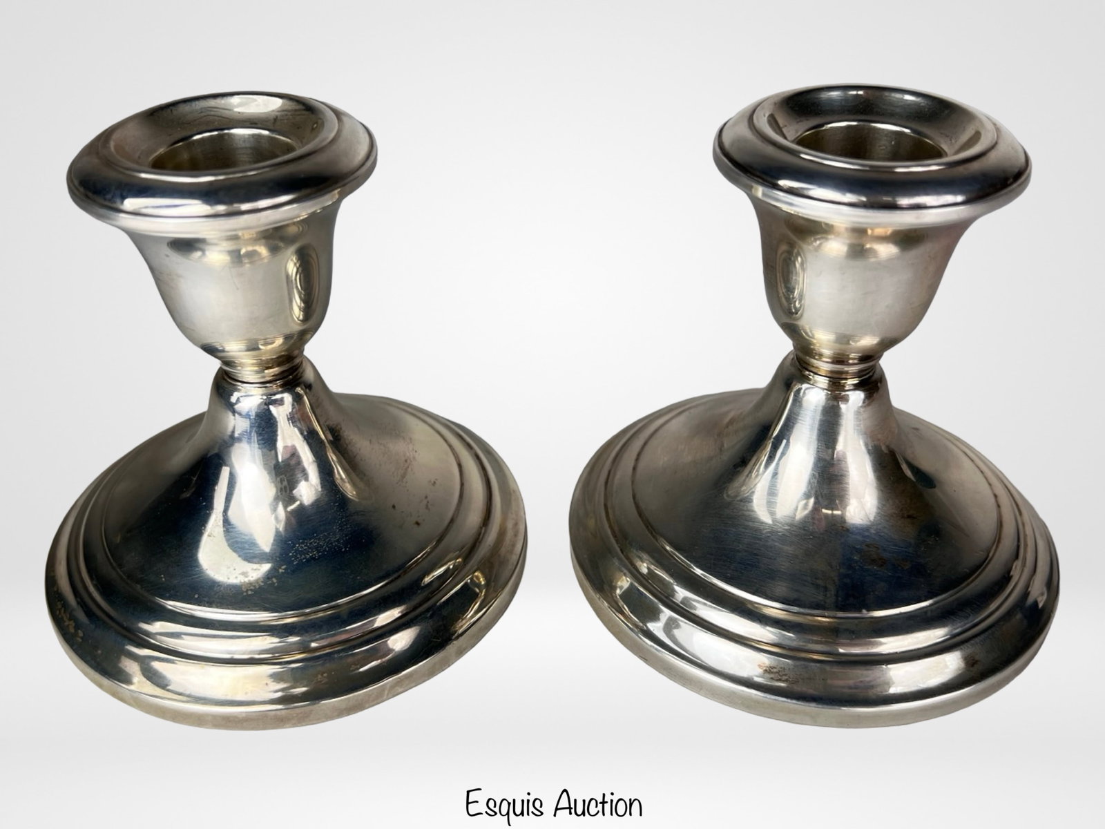 Pair of Gorham Sterling Silver Candleholders: Elegant pair of vintage Gorham sterling silver candleholders featuring a clean and timeless stepped design with broad circular bases and polished finish. A versatile and sophisticated addition to trad