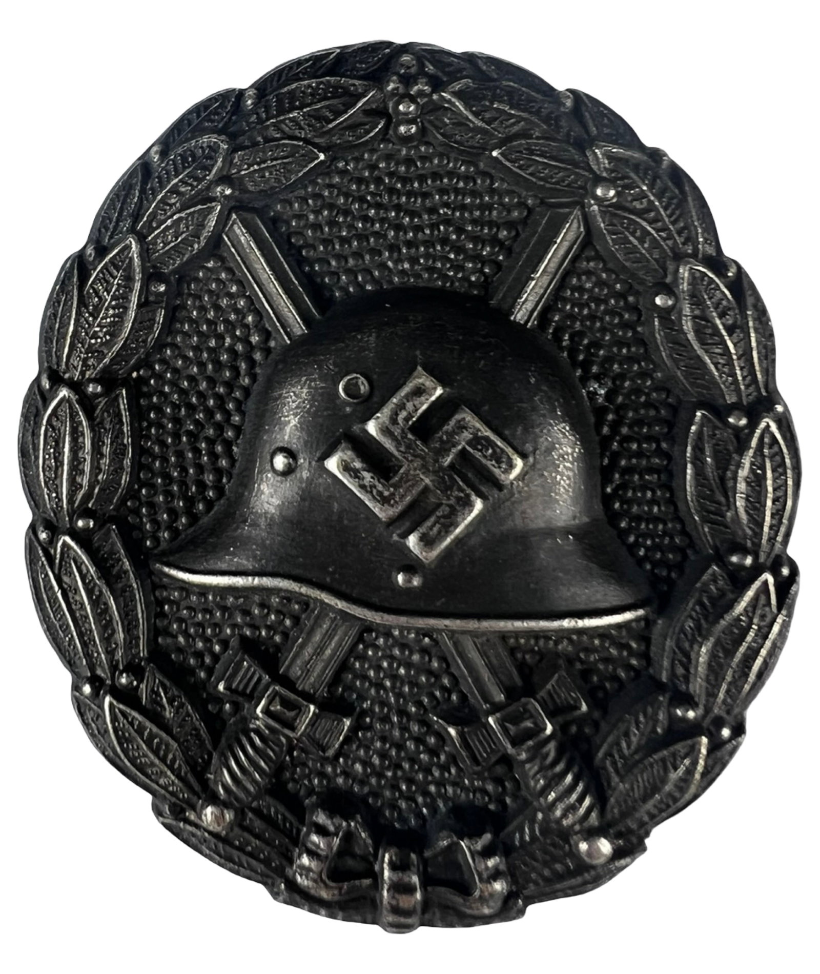 WWII German Black Wound Badge 1st Pattern: Early pattern German Black Wound Badge featuring helmet with crossed swords within a laurel wreath. This example shows a solid construction with screw-back attachment, consistent with early issue piec