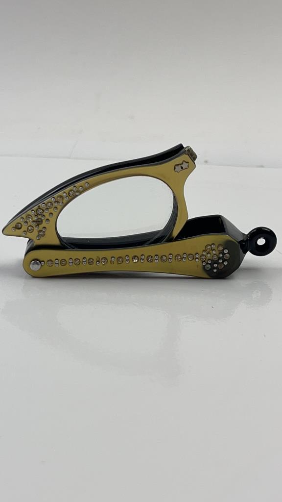 Mid Century Rhinestone Cat Eye Reading Glasses: Vintage Mid Century Rhinestone Cat Eye Reading Glasses. Super unique and fun. Glasses fold out from handle. They have a very pretty cat eye shape. Shiny gold tone color on the front with rhinestones a