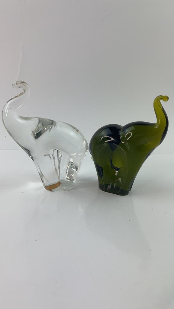 Pair of Black and Clear Murano Elephant: Pair of Very pretty blackish green and clear Murano glass elephant figures with trunks up. Black one marked Pilgram handblown glass. Good Overall condition and weight, Blackish green one measures abou