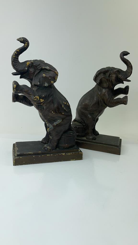 Rare Antique Cast iron Elephant circus bookends: Pair Of very rare Antique cast iron elephants sitting on barrels bookends. Possibly used as door stops. Good overall condition Heavy wear and use on one of them. Very rare hard to find and its a match