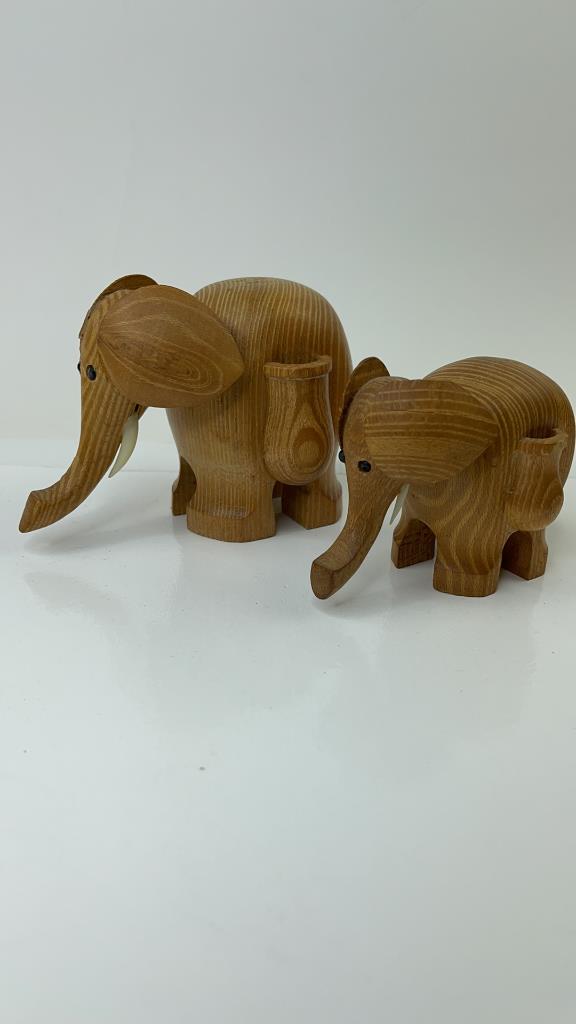 Mother and baby Danish Wood elephant toothpick: Crafted in the Danish fashion out of wood mother snd baby tooth pick holders. Good OVerall condition baby has small chip on tail. Mother measures about 5"L x 3.5"T and the baby measures about 3.5"L x