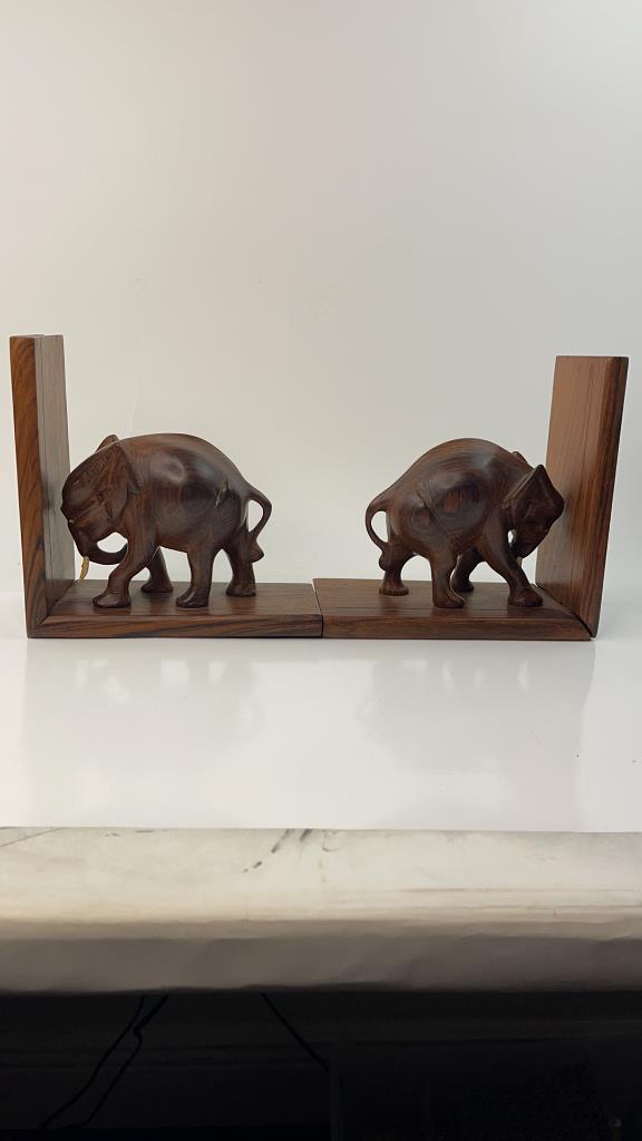 Hand Carved Wood Anglo Indian Elephant Bookends: Good Detail and weight. Great pair all hand crafted from wood. Complete with Tusks. Good Overall condition. Measures about 7"l x 7"T