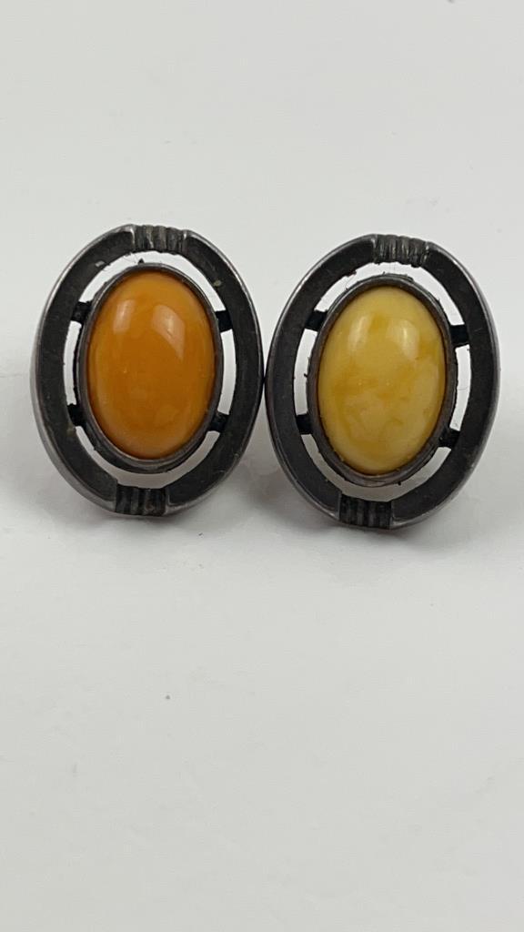 Sterling Silver Baltic Egg Yolk Amber Earrings: Vintage Sterling Silver Baltic Egg yolk Amber Earrings. Very simple and pretty earrings. One stone has more orange tones the other has more yellow tones. For Pierced ears only. Almost 2" long. Good Ov