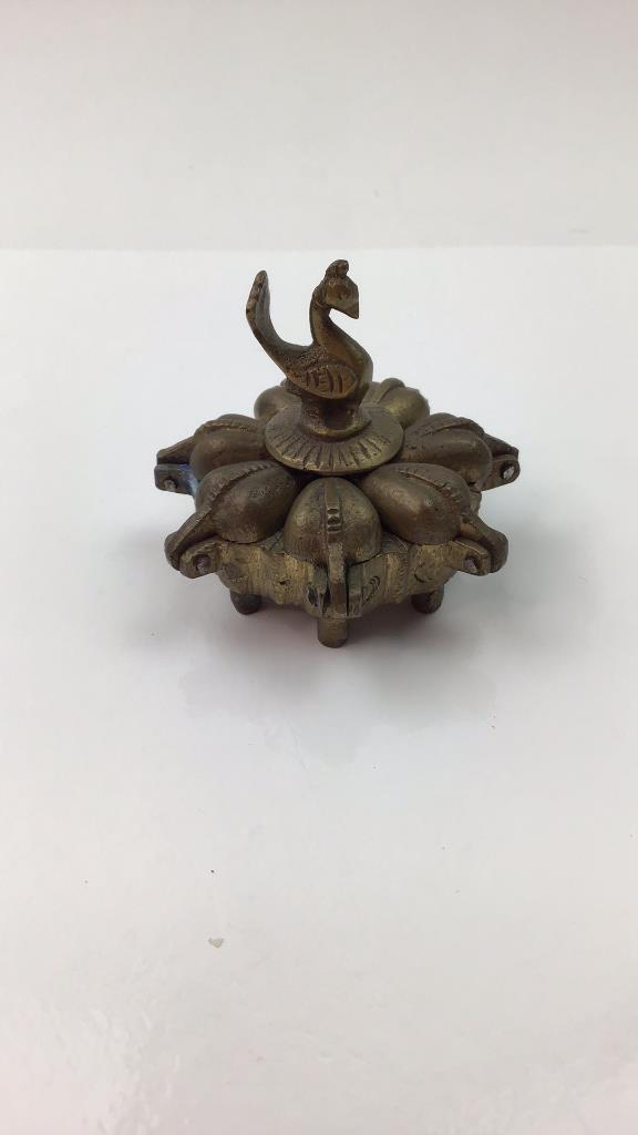 Antique Hindu Indian Kumkum 7 hinged spice box: Antique primitive Hindu Indian brass bronze 7 hinged spice box. ritual box. Center hold a peacock figure that unscrews to unlock the spice compartments. Great one of a kind item. Good overall conditio
