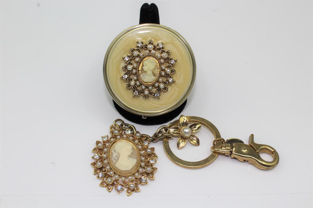 Gold Tone Cameo Rhinestone Pearl Pill Box and Keyg: Gold Tone With faux pearl and rhinestone Cameo hinged pill box and Key Ring. Good Overall Condition and very pretty. No Stones or accents missing. Push button pill case has a divider on the inside. Pi