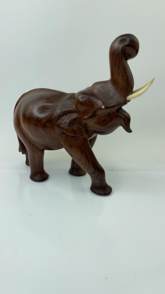 Hand Carved Trunk up Wooden Elephant Sclupture: Very Nice moderatly sized wood elephant with good overall condition and weight. Complete with tusks. Good Overall condition. Measures about 10.5"L x 7 1/4"T $30.00 US Shipping